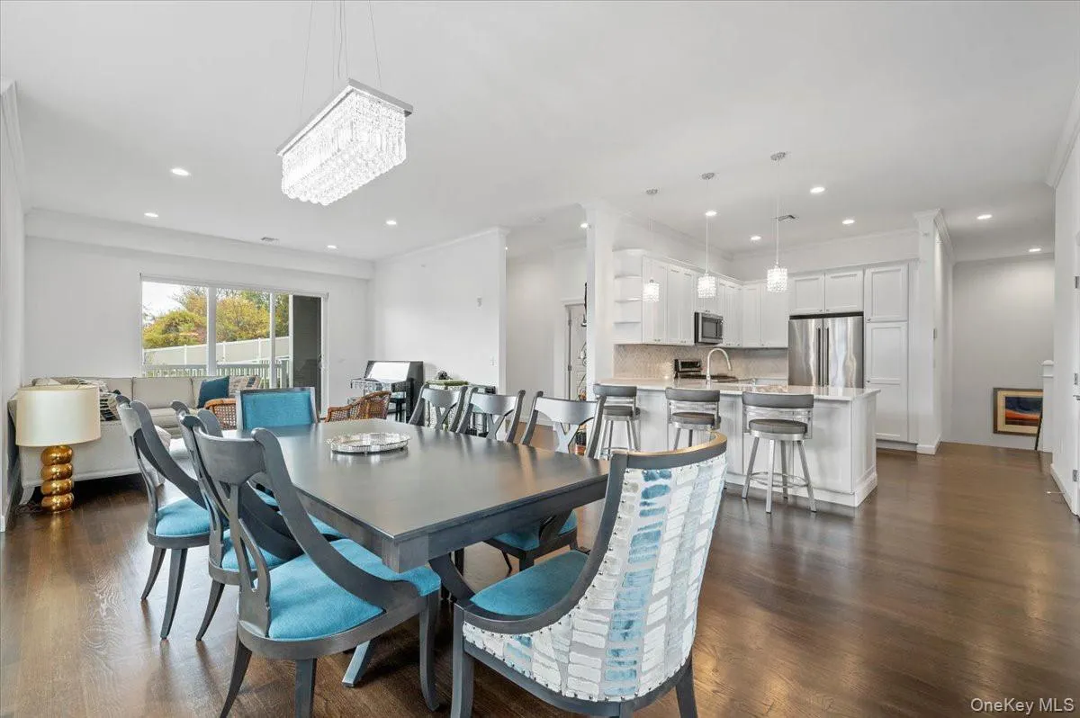 Dining space with dark woodstyle floors, recessed lighting,and crown molding Dining space with dark woodstyle floors, recessed lighting,and crown molding