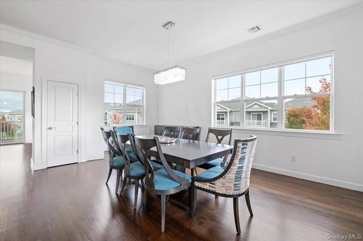 Dining area with ornamentalmolding and dark wood-stylefloor Dining area with ornamentalmolding and dark wood-stylefloor