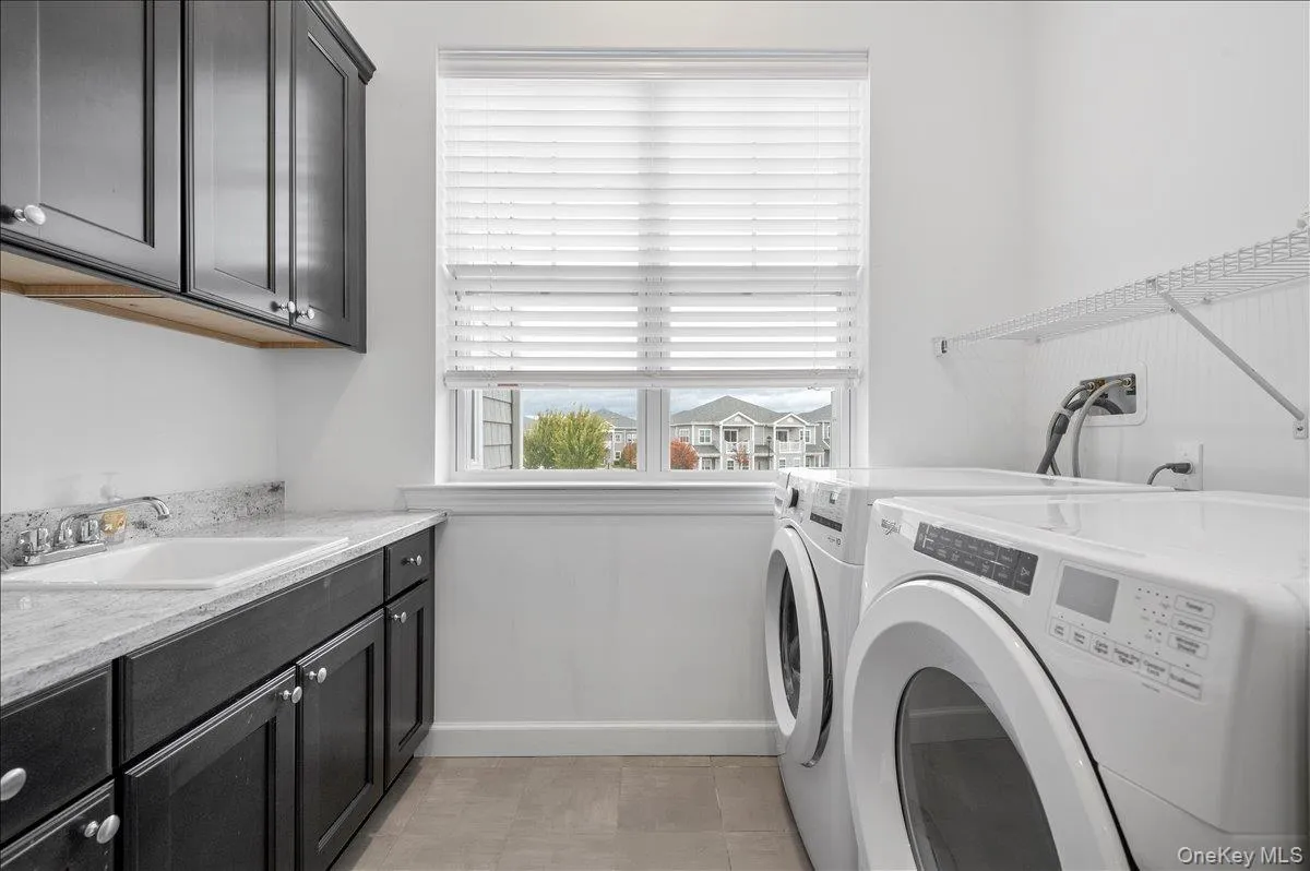 Laundry area featuring washerand clothes dryer and cabinet space Laundry area featuring washerand clothes dryer and cabinet space