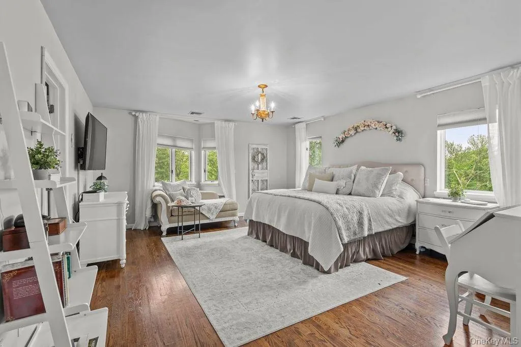 Large Primary bedroom with hardwood floors. Large Primary bedroom with hardwood floors.