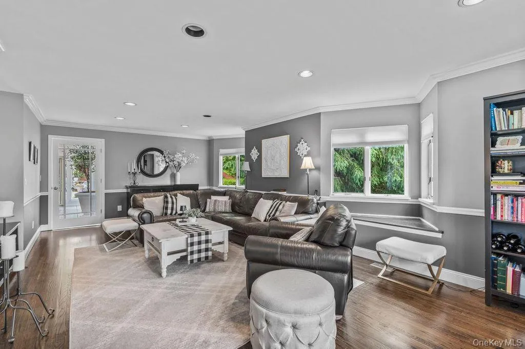 Living room featuring wood floors, recessed lighting, and crown molding Living room featuring wood floors, recessed lighting, and crown molding