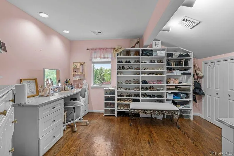 Enormous walk in closet with hardwood floors. Enormous walk in closet with hardwood floors.