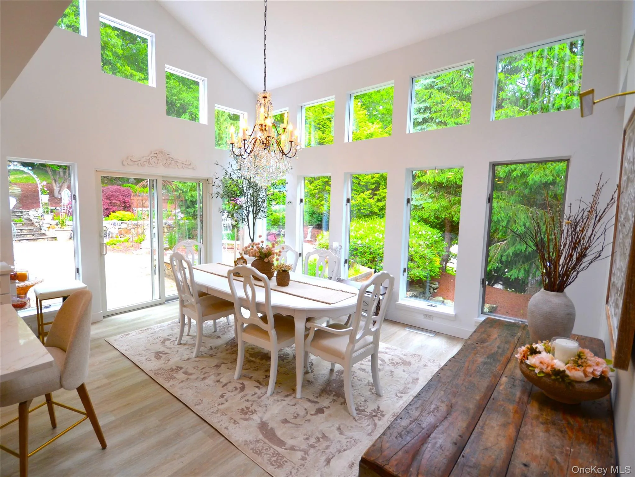 Dinning room with cathedral ceilings and new flooring. Sliding glass door to court yard. Dinning room with cathedral ceilings and new flooring. Sliding glass door to court yard.