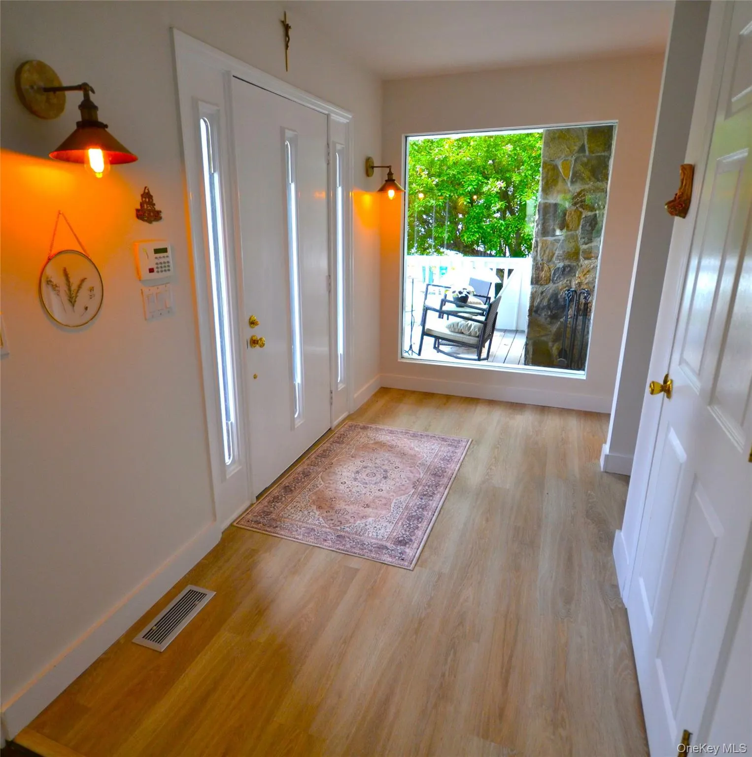 Entry with new flooring. Large glass panel to let the outside in. Entry with new flooring. Large glass panel to let the outside in.