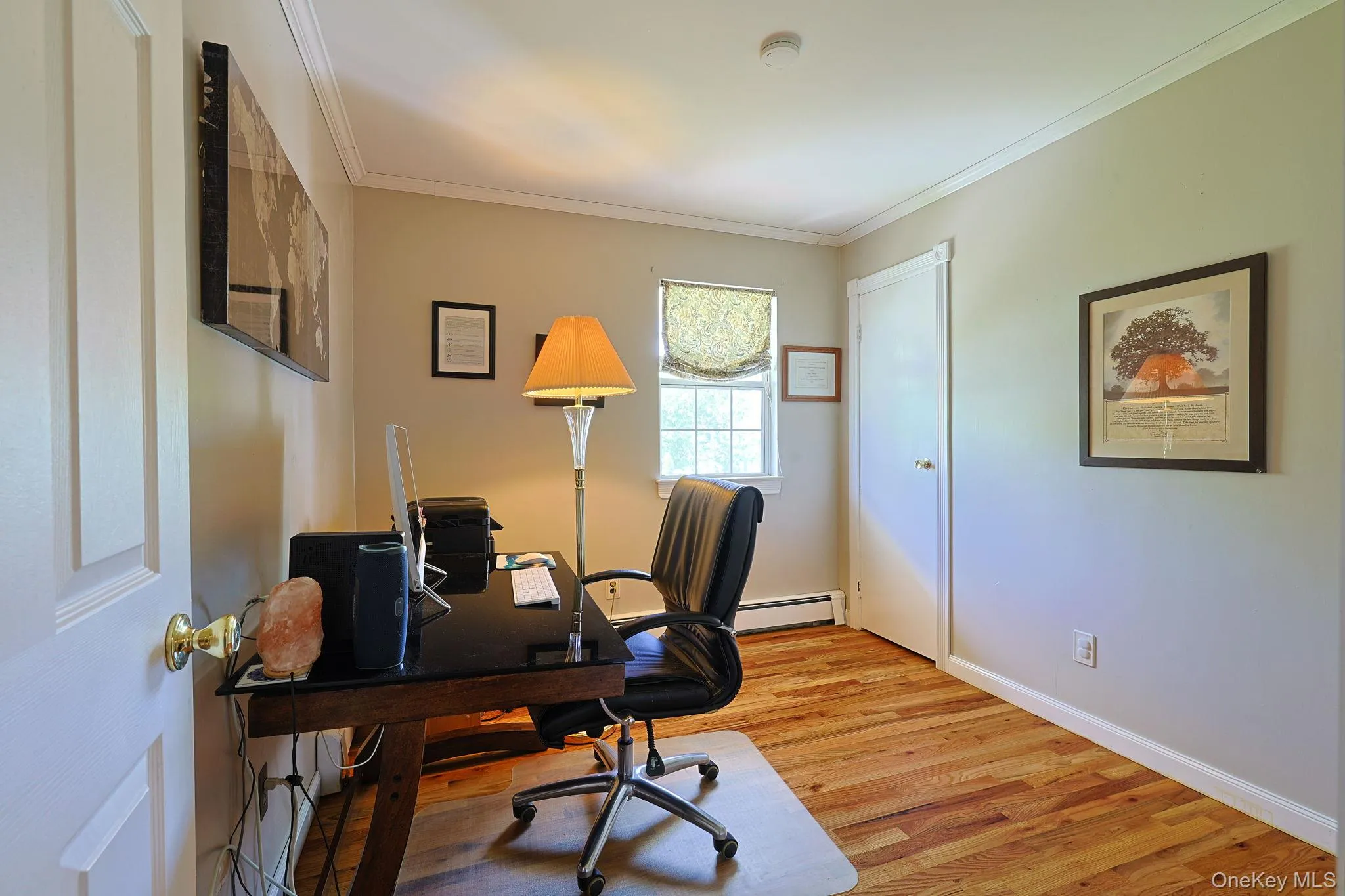 Hardwood flooring paired with neutral wall tones in this bedroom. Currently utilized as a home office. Hardwood flooring paired with neutral wall tones in this bedroom. Currently utilized as a home office.