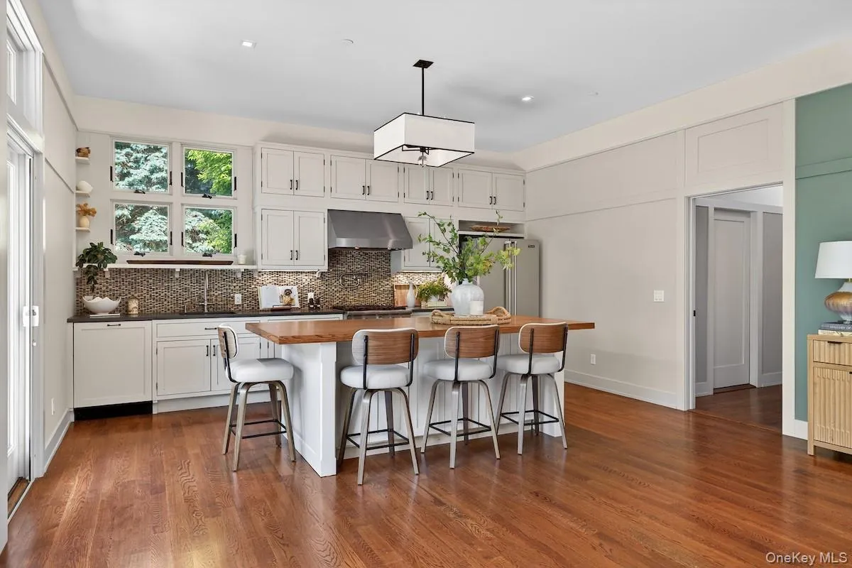 Kitchen with stainless steel appliances, Viking range, Cesarstone counter surfaces, mosaic glass tile backsplash Kitchen with stainless steel appliances, Viking range, Cesarstone counter surfaces, mosaic glass tile backsplash