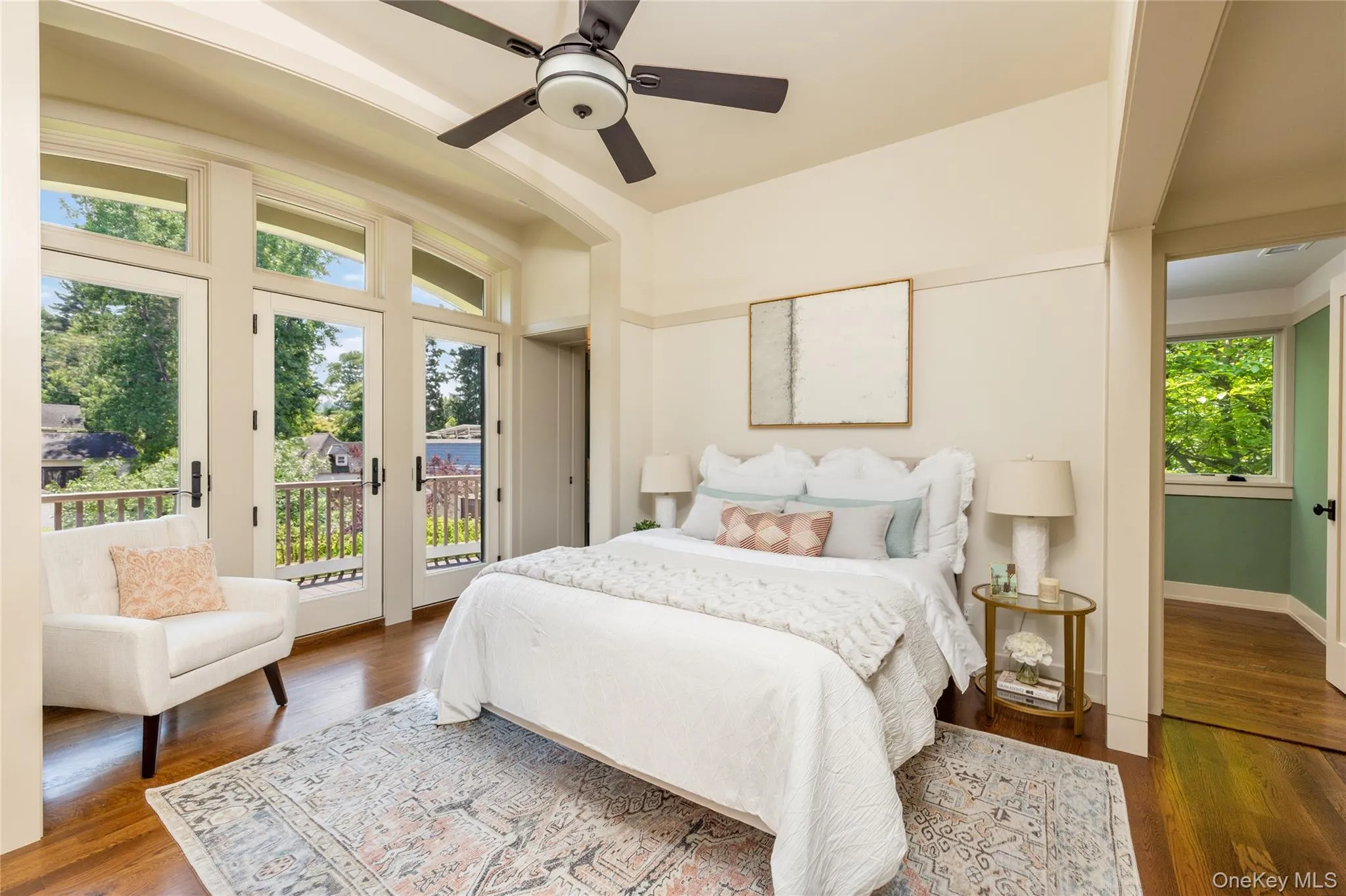 Primary bedroom with doors to private balcony Primary bedroom with doors to private balcony