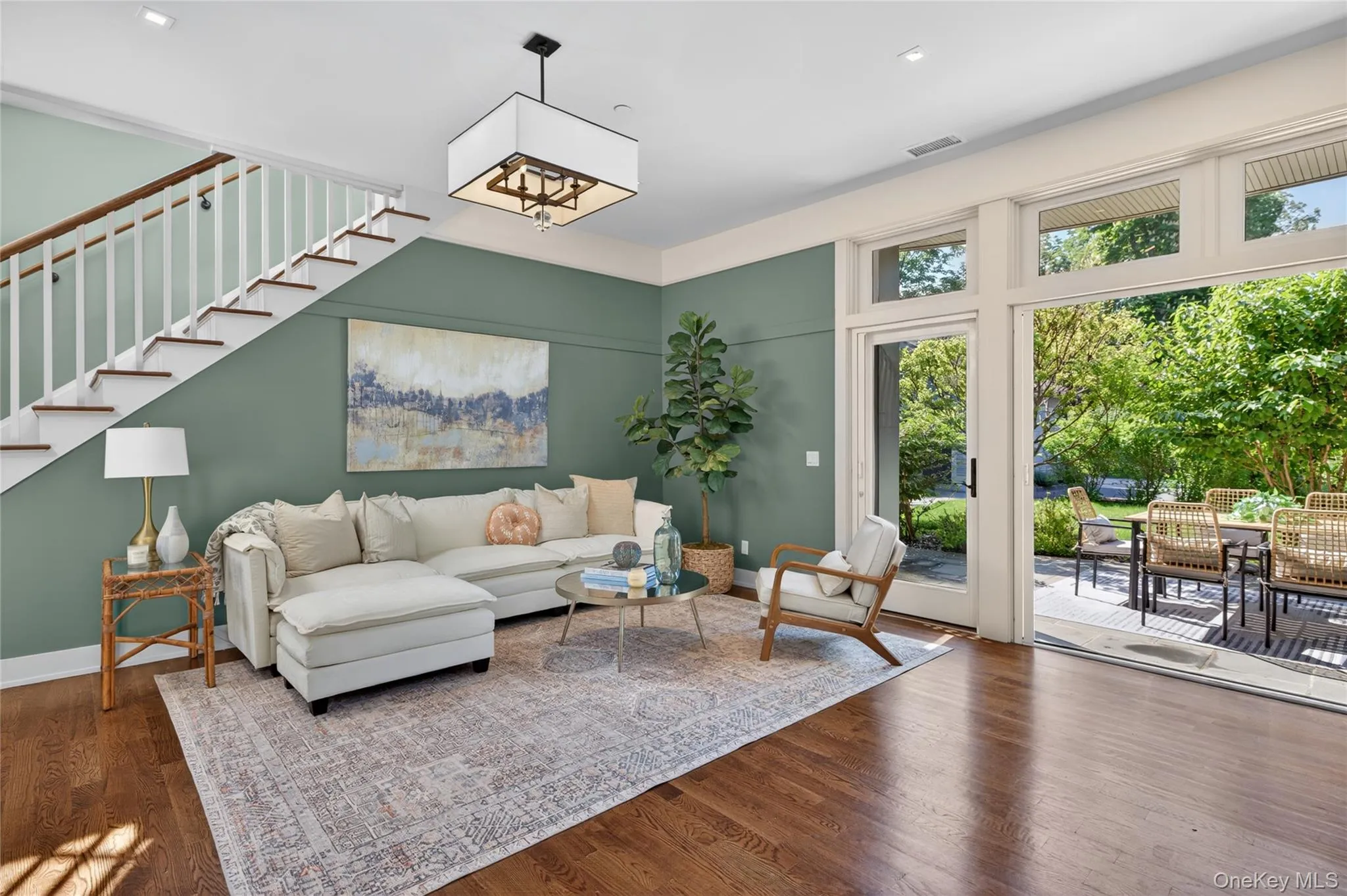 Spacious living room with 4 French doors to bluestone patio Spacious living room with 4 French doors to bluestone patio