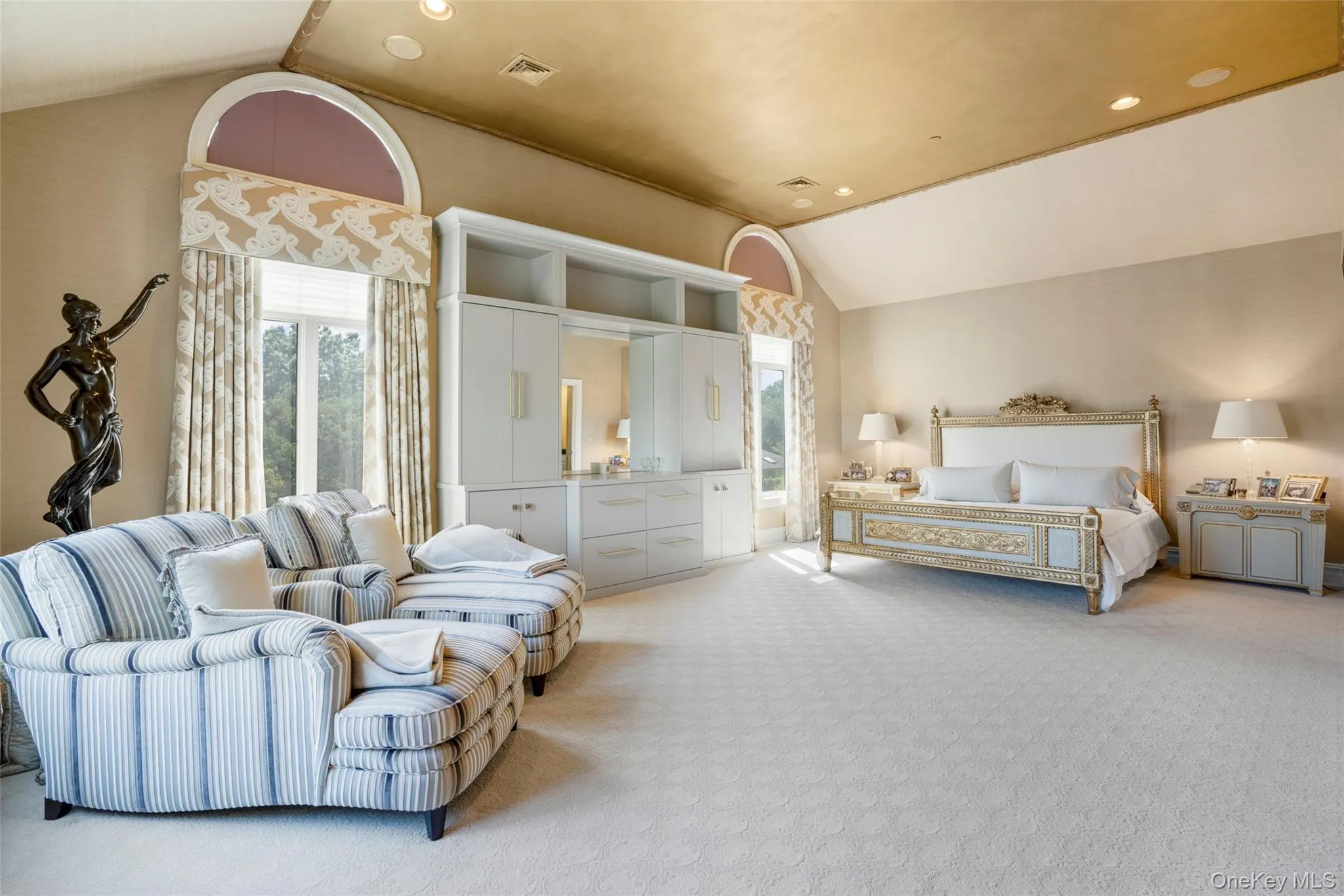 Vaulted ceilings and double exposure create a luxury primary suite with a spa bathroom and generous closet space Vaulted ceilings and double exposure create a luxury primary suite with a spa bathroom and generous closet space