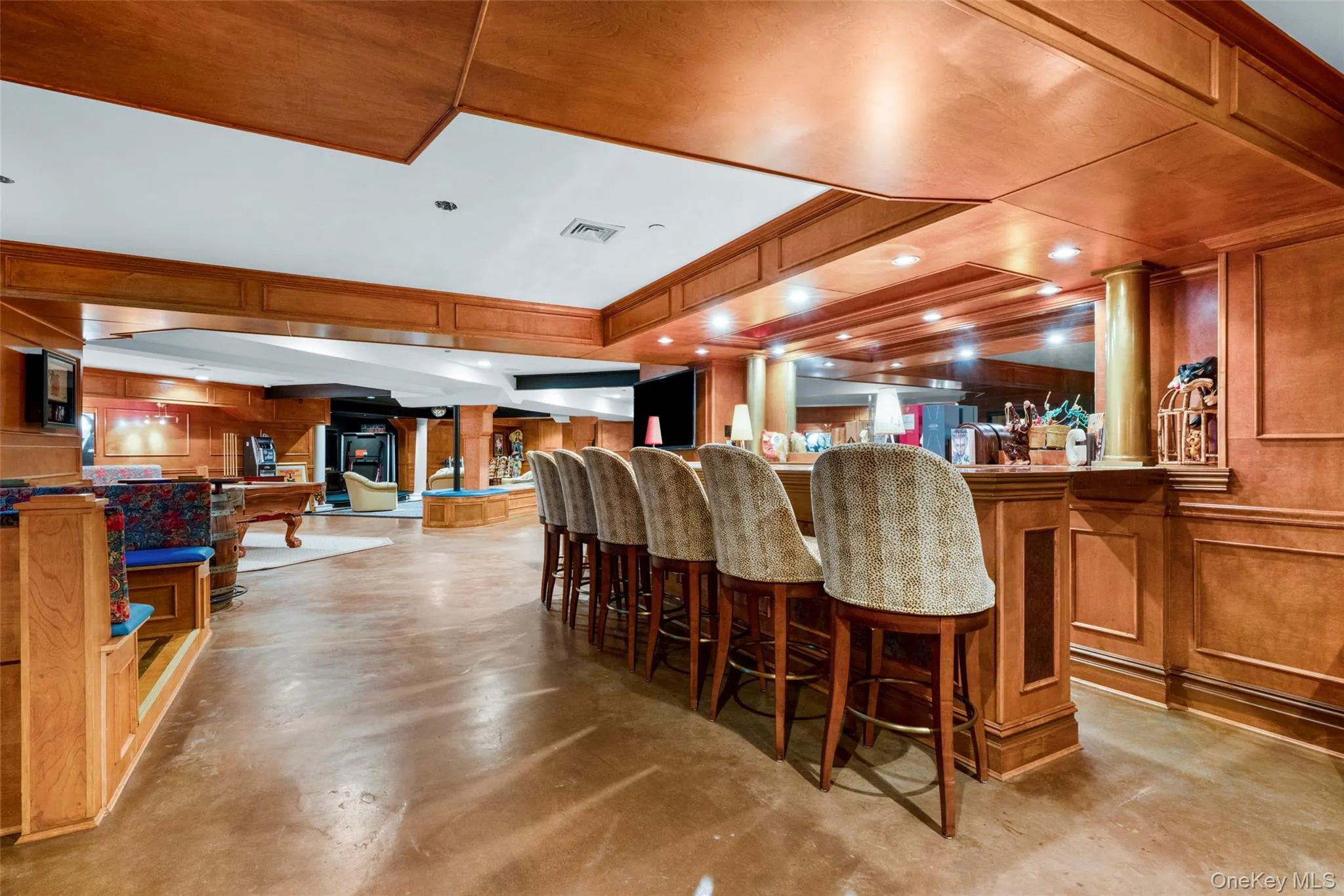 Large custom bar and stunning concrete floors throughout the lower level Large custom bar and stunning concrete floors throughout the lower level