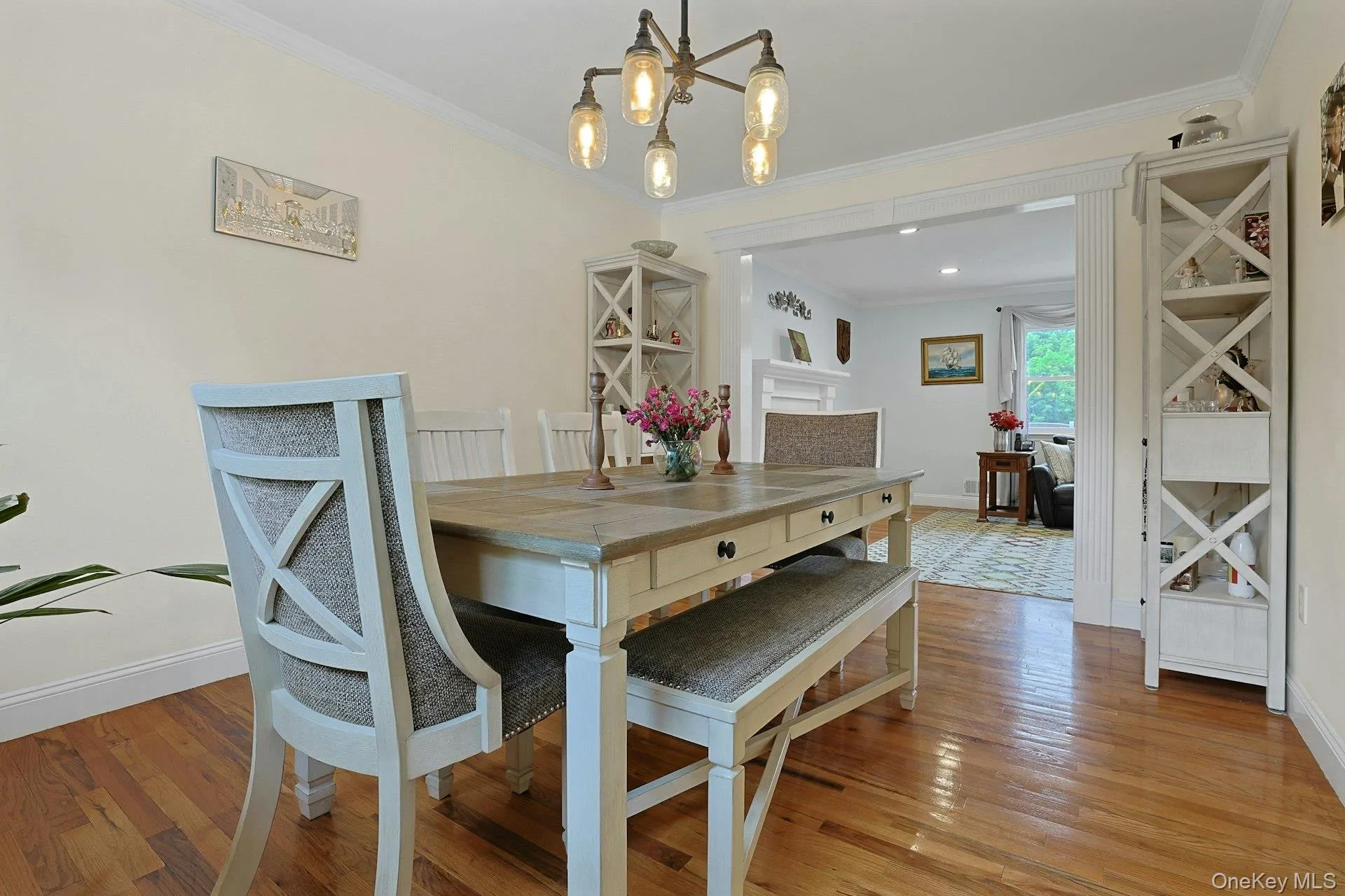 Hardwood flooring throughout the dining area, featuring a decorative chandelier and built-in shelving Hardwood flooring throughout the dining area, featuring a decorative chandelier and built-in shelving