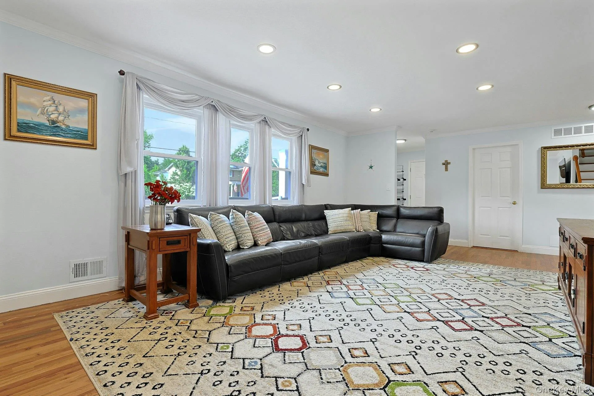 Living area featuring light wood-finish flooring and a white trim package Living area featuring light wood-finish flooring and a white trim package