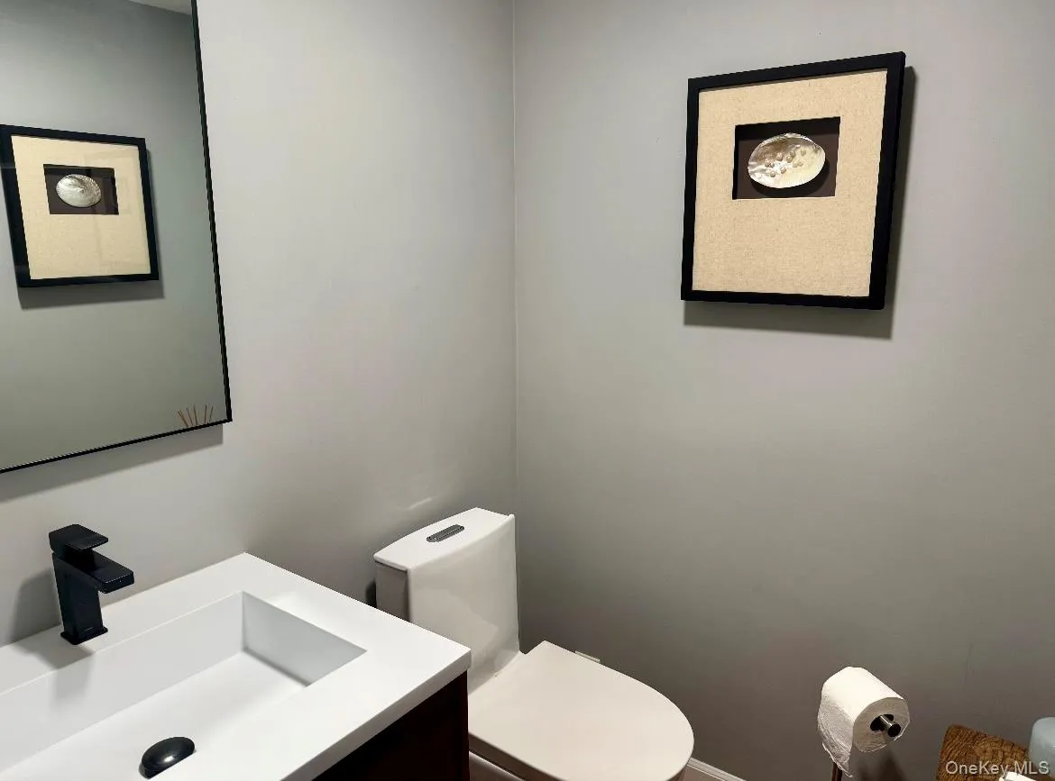 Bathroom with toilet and vanity Bathroom with toilet and vanity