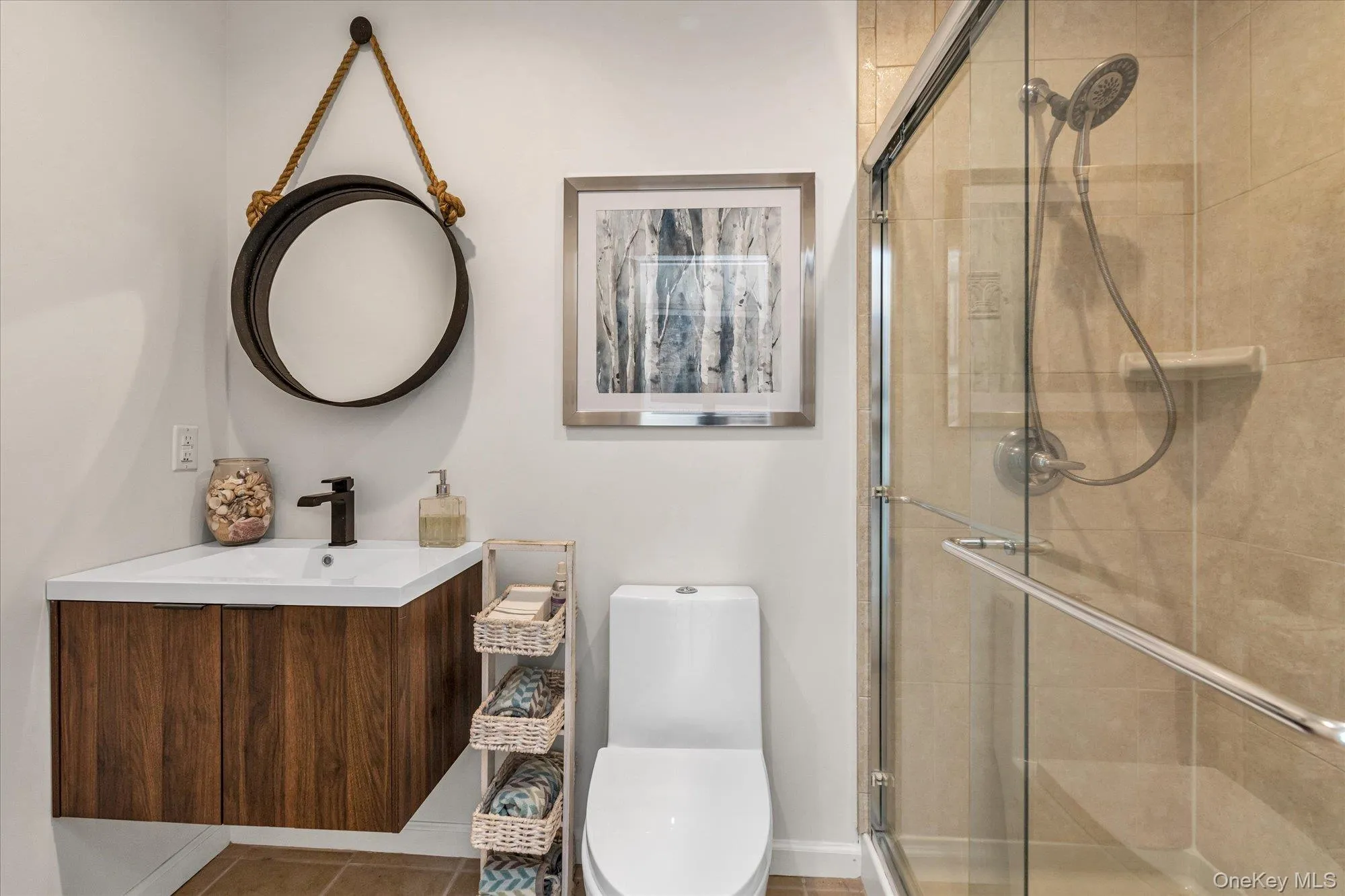 Bathroom with vanity, a stall shower, and tile patterned flooring Bathroom with vanity, a stall shower, and tile patterned flooring