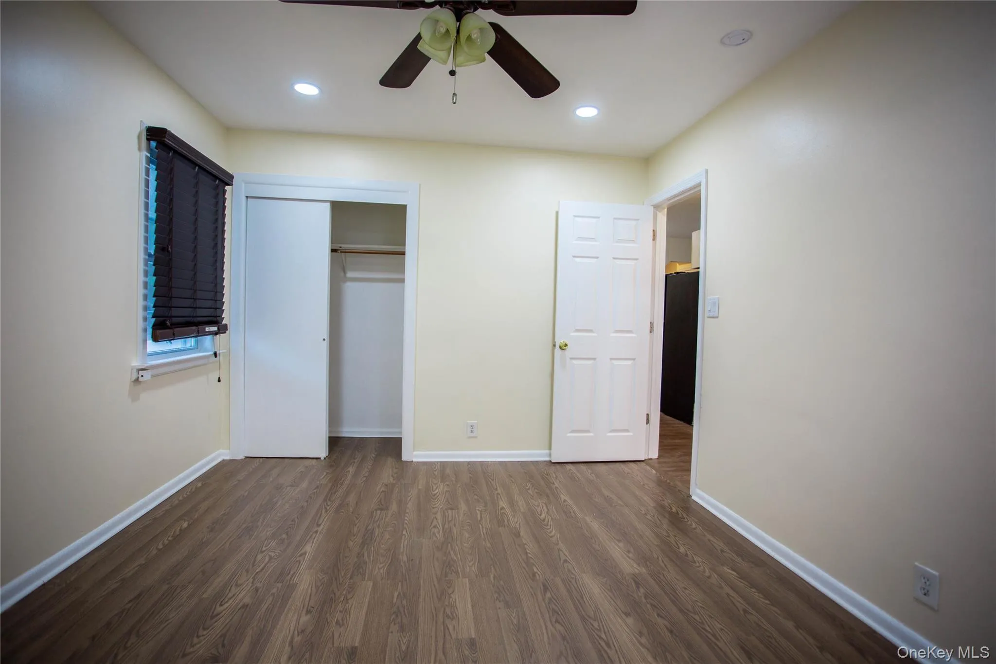 Unfurnished bedroom featuring baseboards, dark wood-style floors, recessed lighting, and a closet Unfurnished bedroom featuring baseboards, dark wood-style floors, recessed lighting, and a closet
