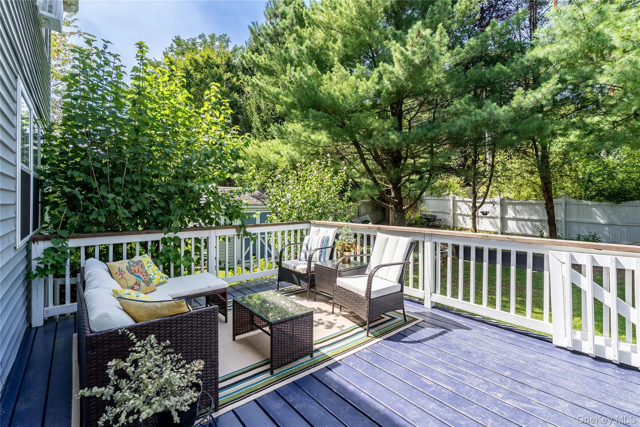 Wooden terrace featuring an outdoor hangout area and a fenced backyard Wooden terrace featuring an outdoor hangout area and a fenced backyard