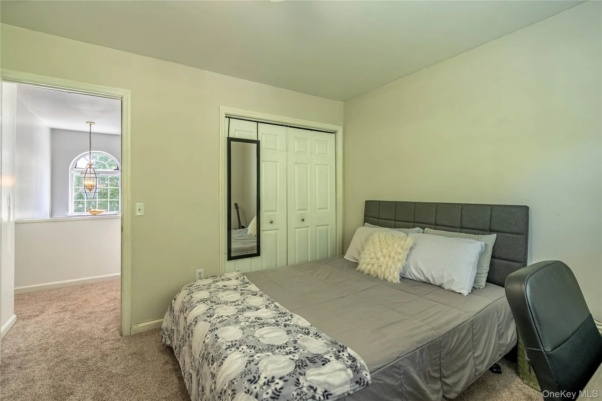 Carpeted bedroom featuring baseboards and a closet Carpeted bedroom featuring baseboards and a closet