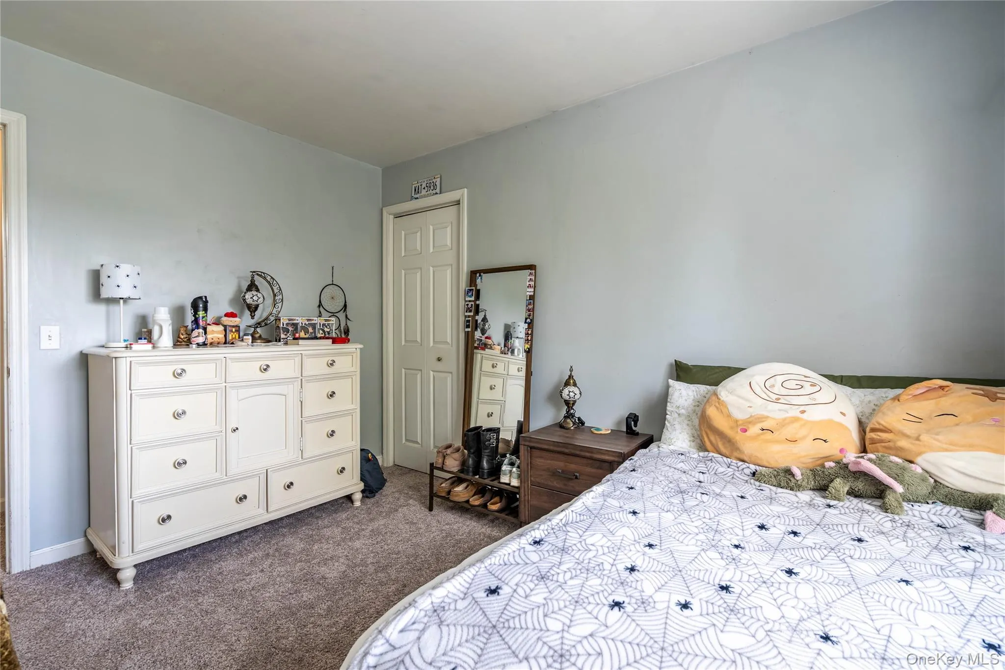 Carpeted bedroom with a closet Carpeted bedroom with a closet