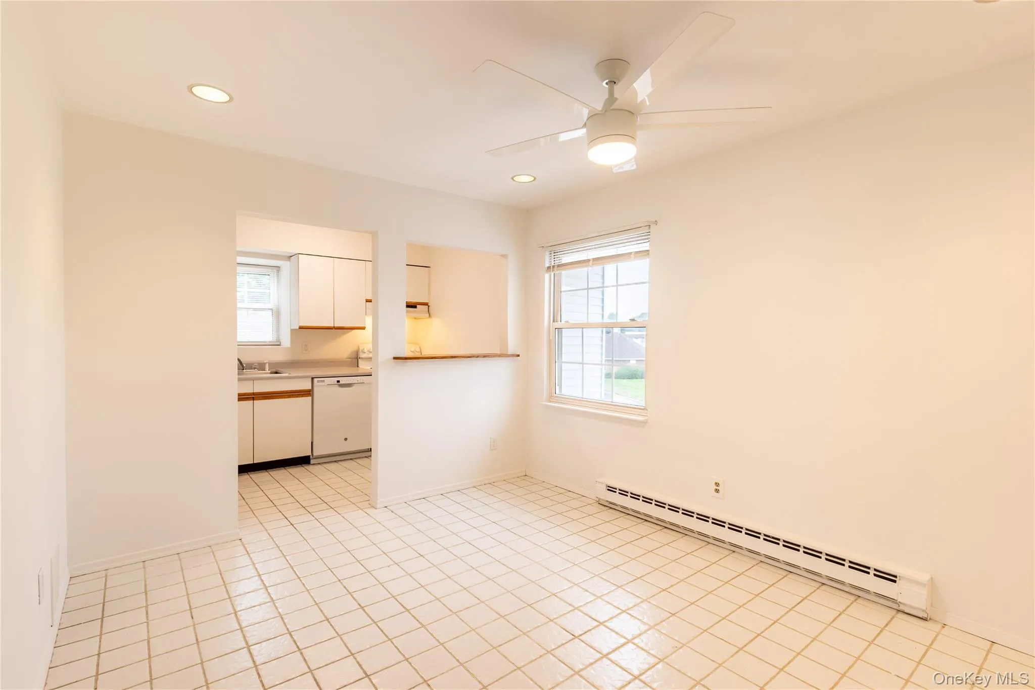 dining room, in front of unit - tile floor, overhead light, ceiling fan, baseboard heat dining room, in front of unit - tile floor, overhead light, ceiling fan, baseboard heat