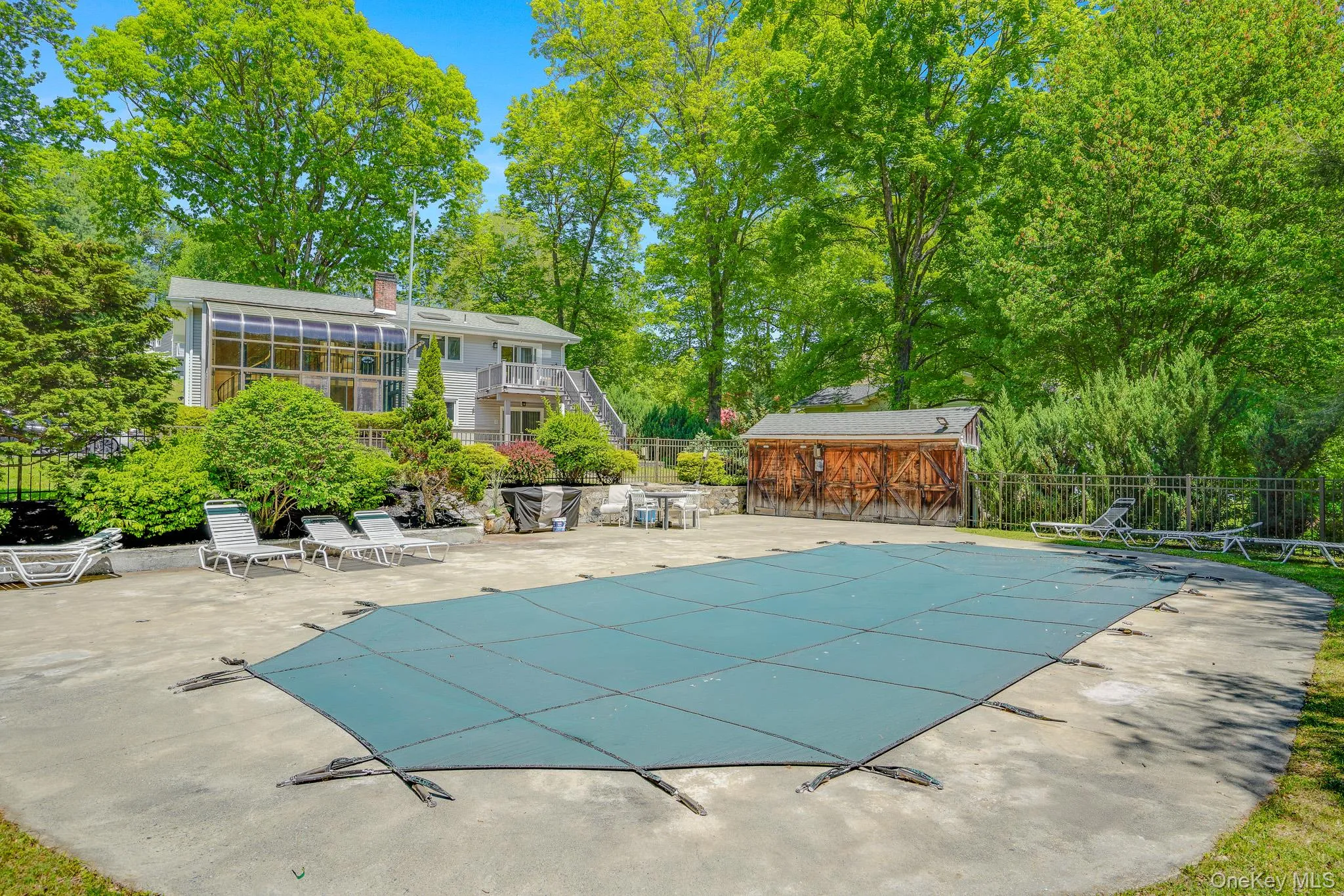 In-ground pool and shed to store pool items. In-ground pool and shed to store pool items.