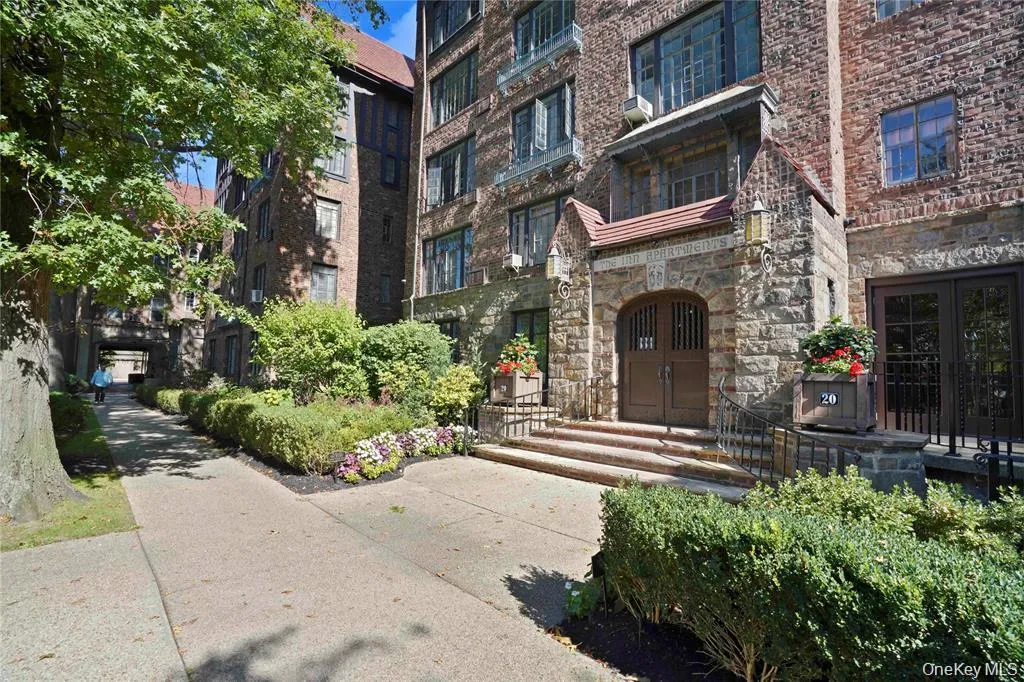Stone and brick facade building with a prominent arched stone entryway Stone and brick facade building with a prominent arched stone entryway