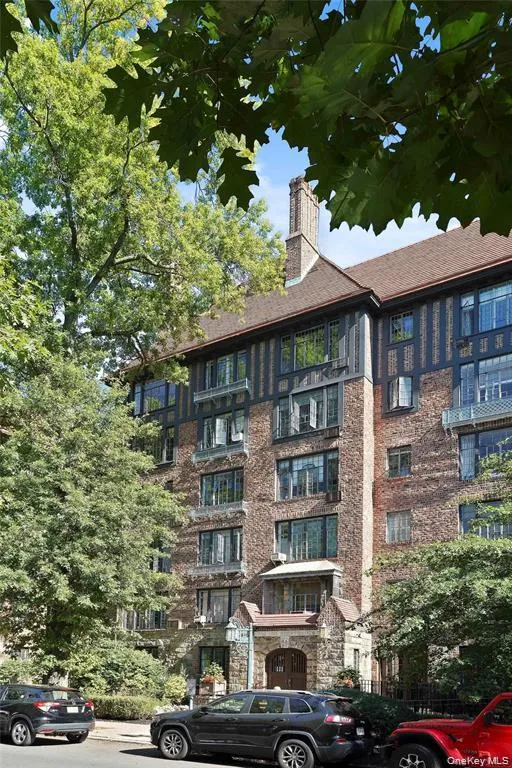 Brick facade building featuring a prominent stone entryway with arched detailing Brick facade building featuring a prominent stone entryway with arched detailing