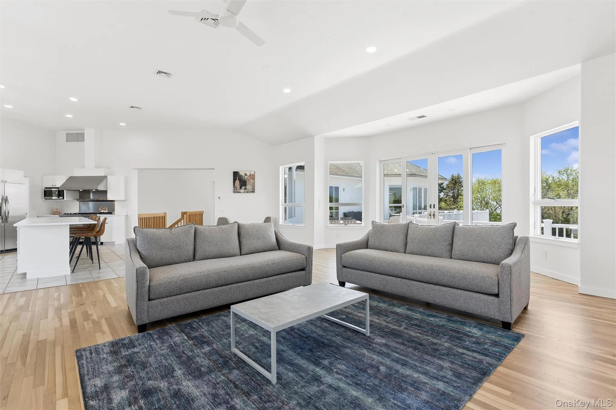 2nd FloorOpen-concept living area with vaulted ceilings, recessed lighting, wood-finish flooring, and expansive windows 2nd FloorOpen-concept living area with vaulted ceilings, recessed lighting, wood-finish flooring, and expansive windows