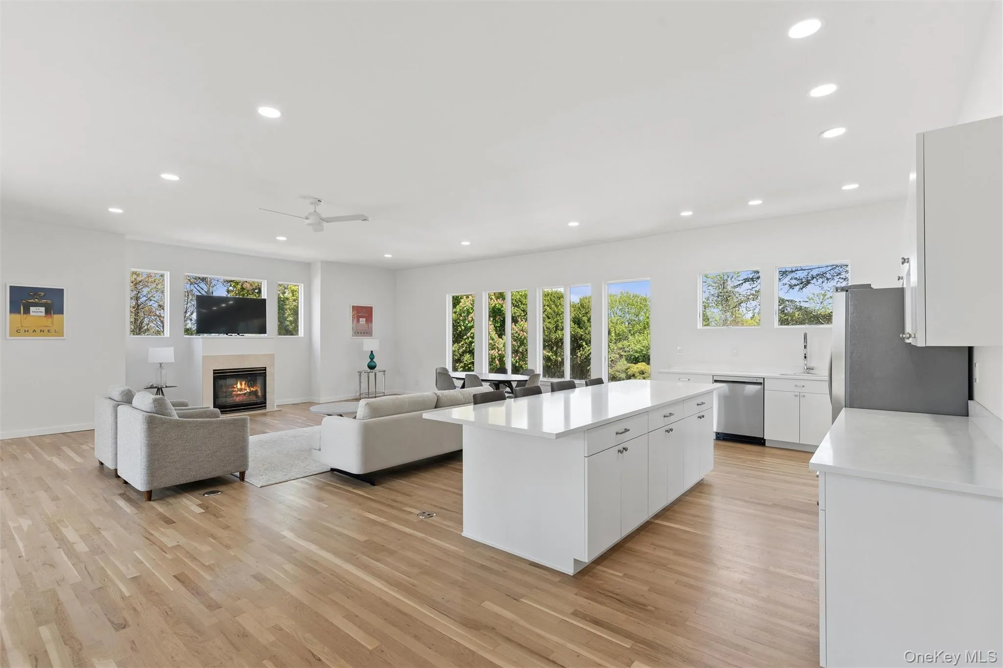 1st floor, Open-concept living space featuring wood-finish flooring, recessed lighting, and ample natural light from multiple windows 1st floor, Open-concept living space featuring wood-finish flooring, recessed lighting, and ample natural light from multiple windows