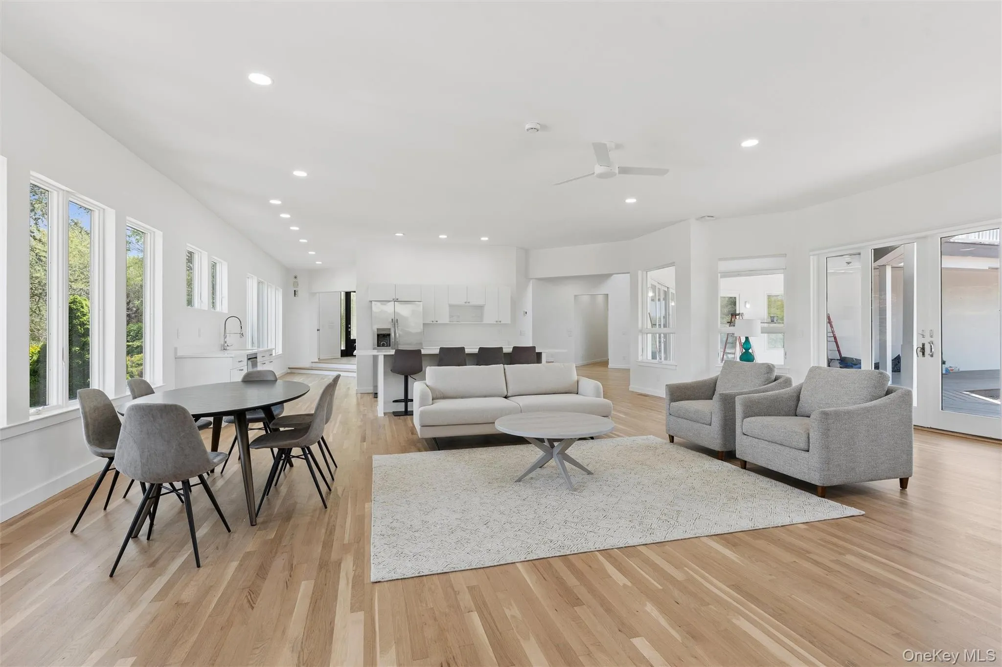 1st Floor Open-concept living space featuring wood-finish flooring, recessed lighting, and multiple windows bringing forth abundant natural light 1st Floor Open-concept living space featuring wood-finish flooring, recessed lighting, and multiple windows bringing forth abundant natural light