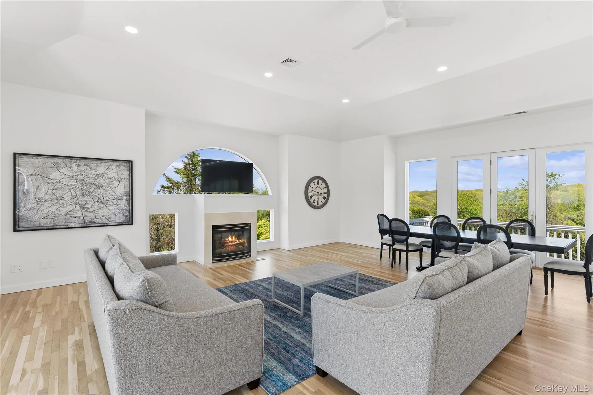 Spacious living area featuring high vaulted ceilings and wood-finish flooring Spacious living area featuring high vaulted ceilings and wood-finish flooring