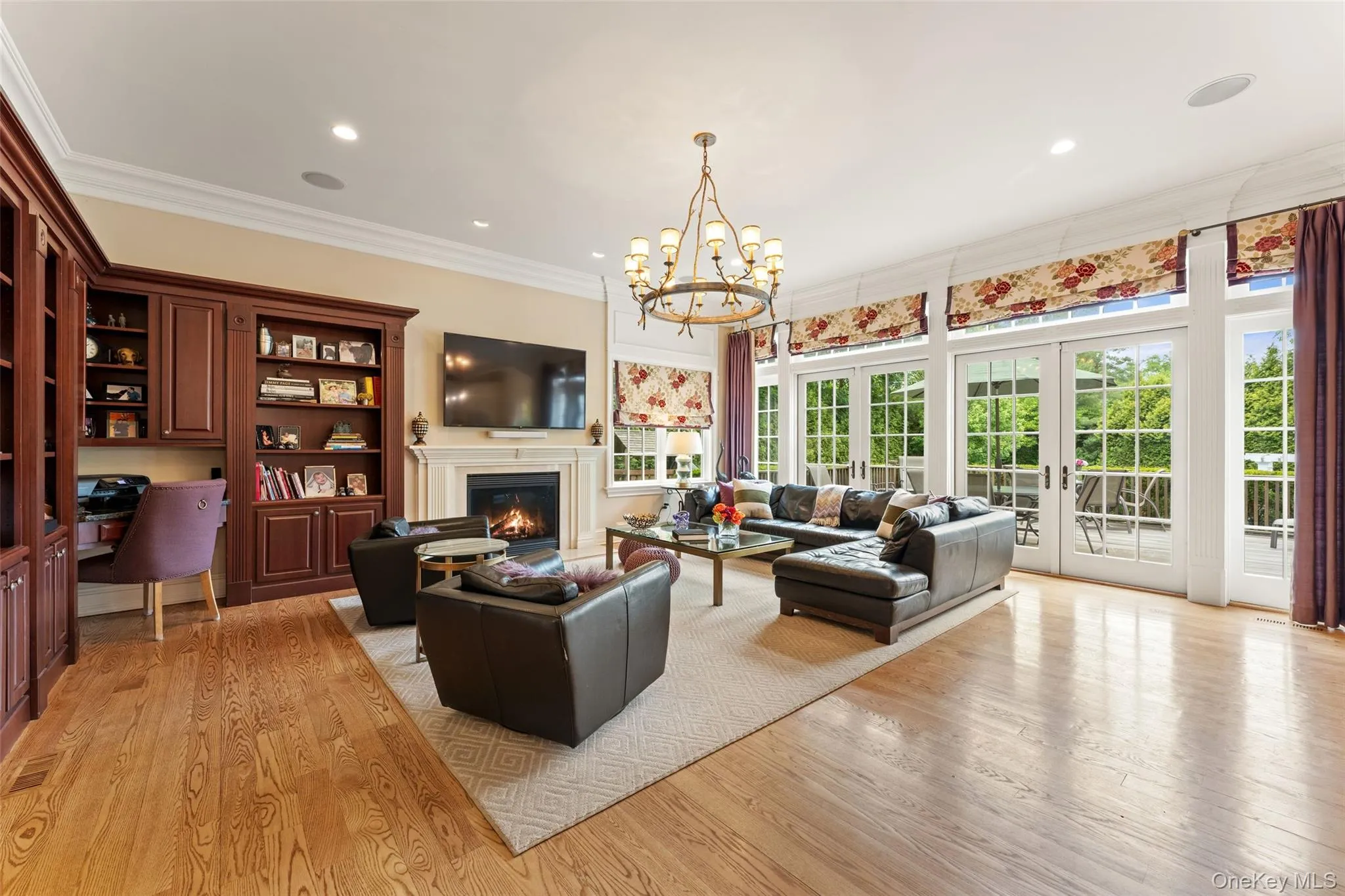 Family room with french foors and custom built in cabinetry Family room with french foors and custom built in cabinetry