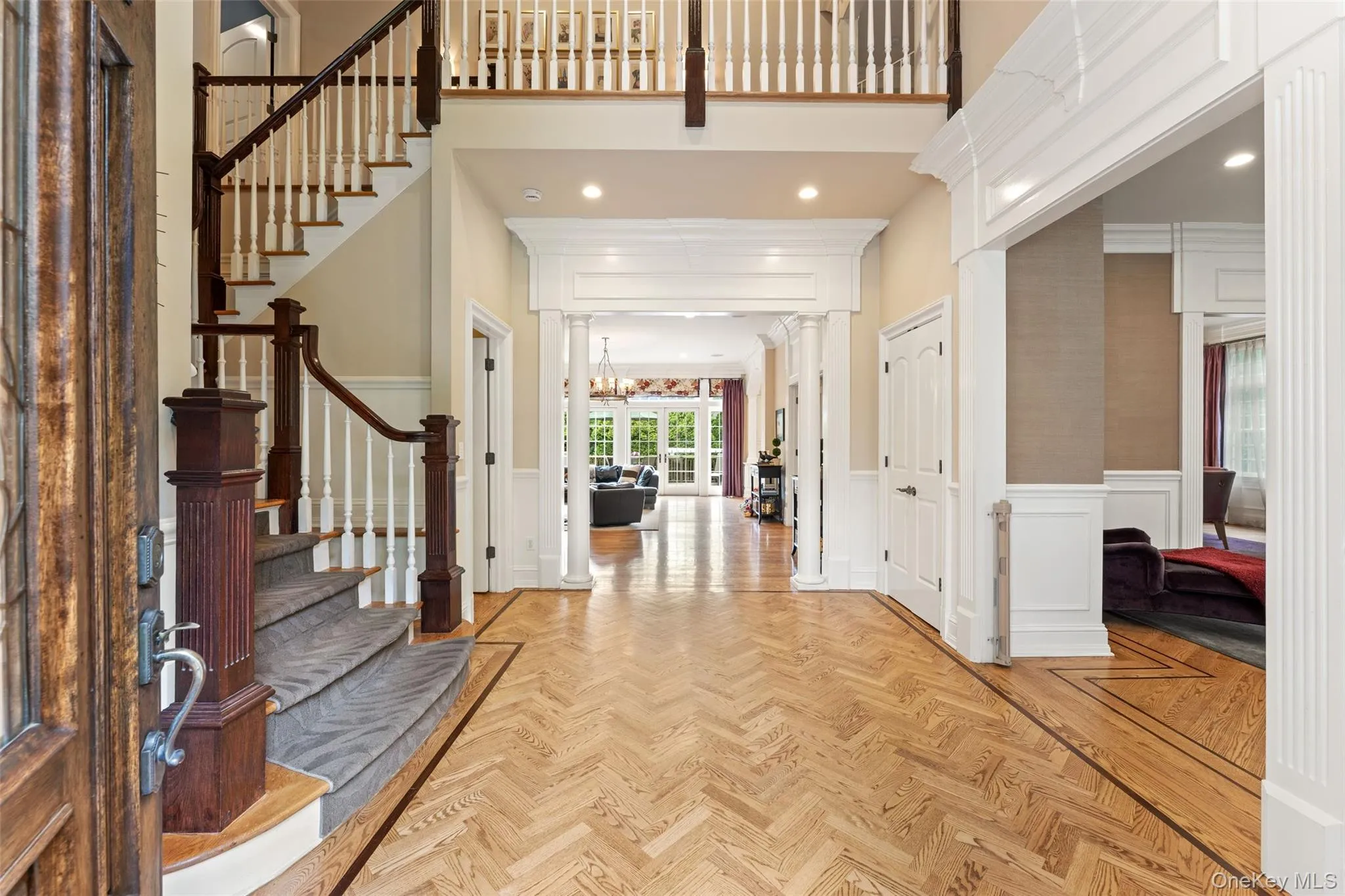 Double height entry foyer with beautiful herringbone floors Double height entry foyer with beautiful herringbone floors