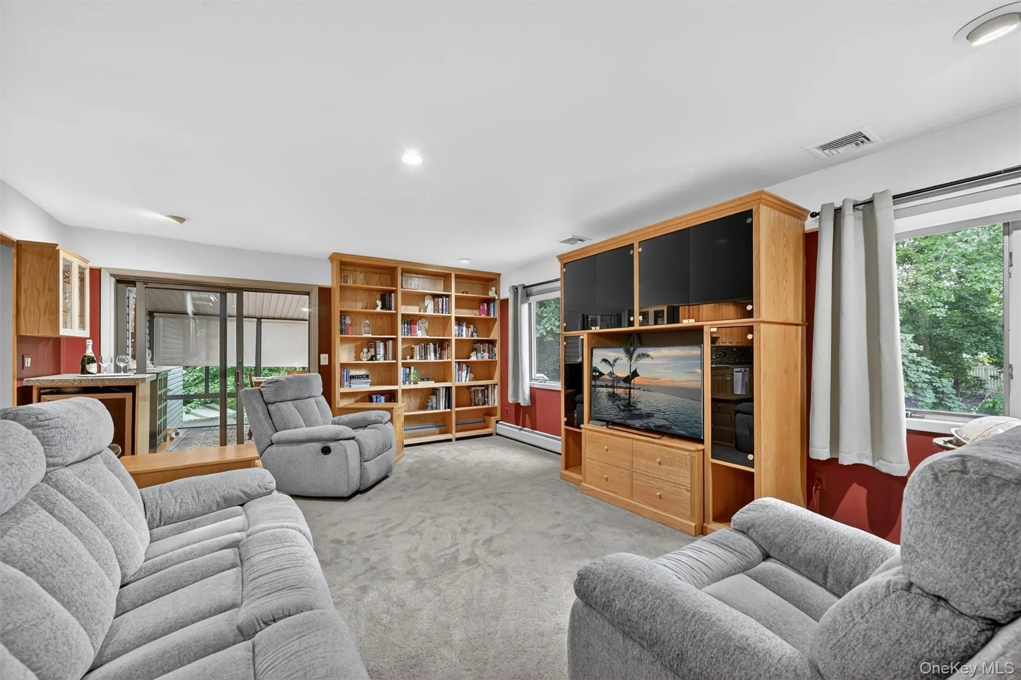 Large open family room with wall-to-wall built-ins, abundant natural light, and direct access to the outdoor living area. Large open family room with wall-to-wall built-ins, abundant natural light, and direct access to the outdoor living area.