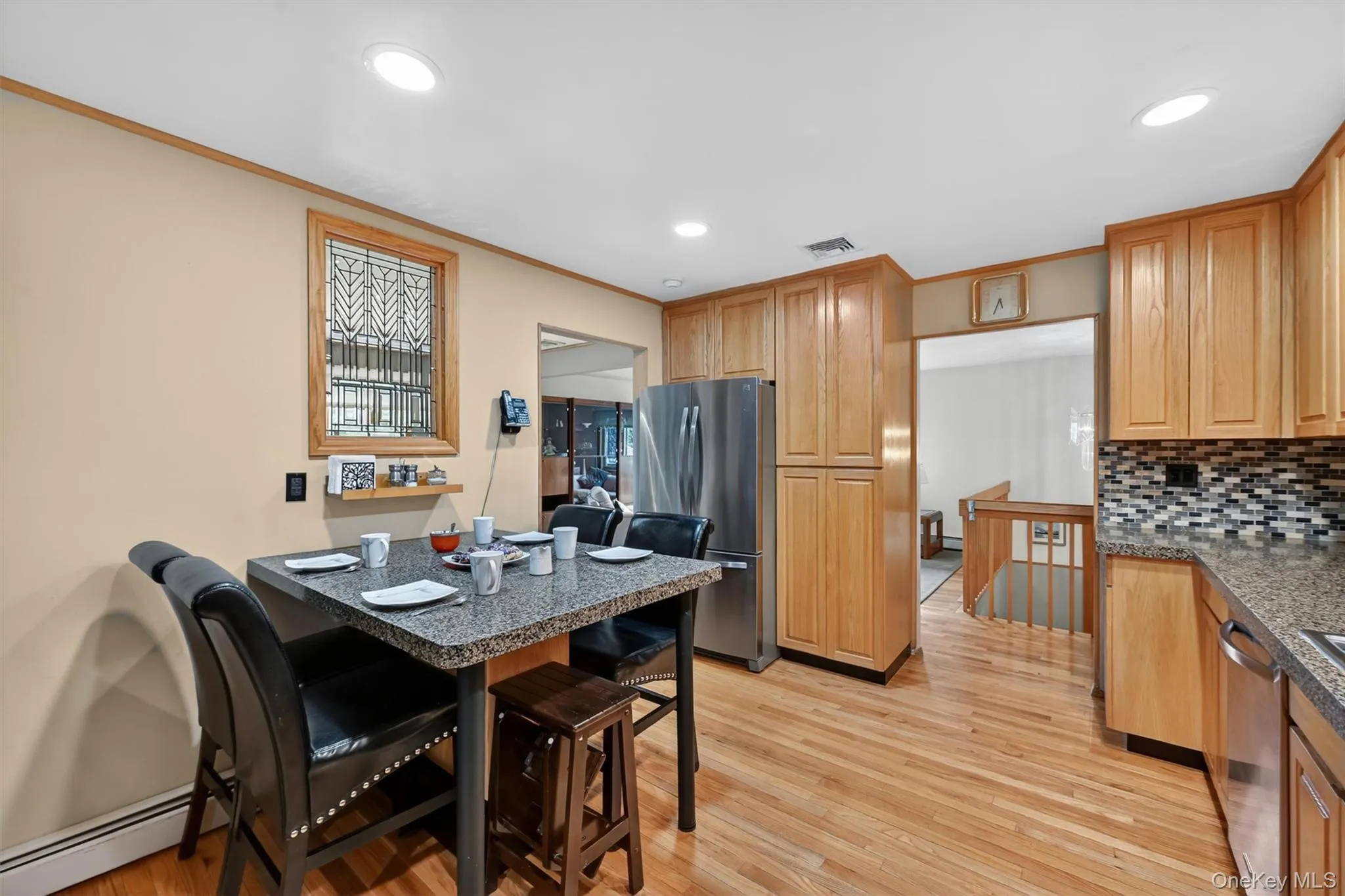 Open-concept kitchen with casual dining space, hardwood floors, and easy access to the adjoining living areas. Open-concept kitchen with casual dining space, hardwood floors, and easy access to the adjoining living areas.