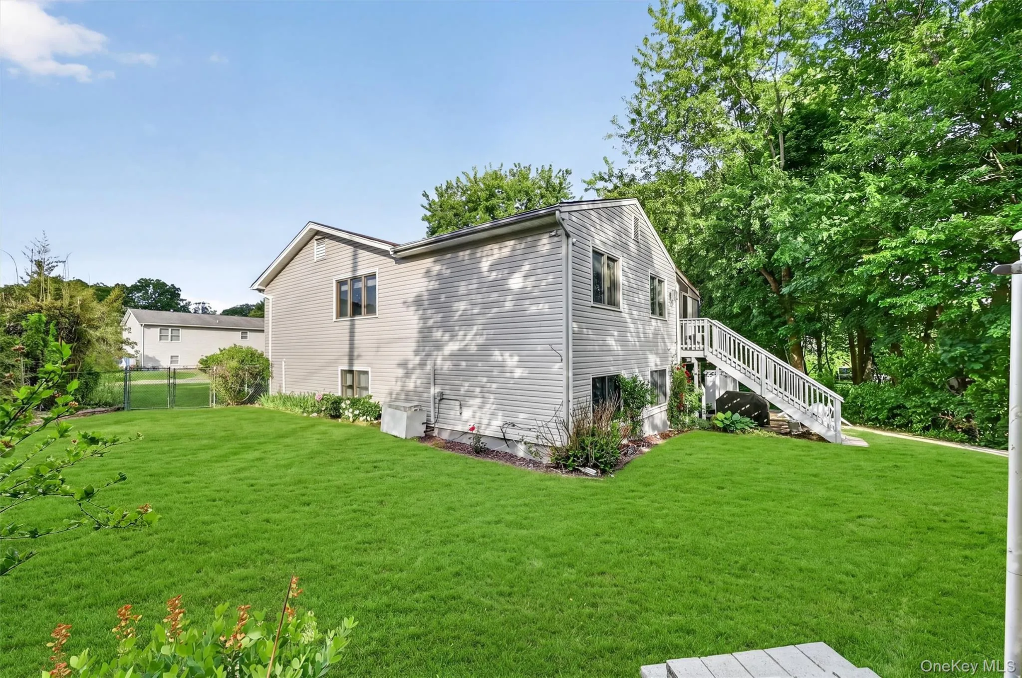 Rear exterior view showcasing the home's spacious yard, private setting, and easy access to outdoor living areas. Rear exterior view showcasing the home's spacious yard, private setting, and easy access to outdoor living areas.