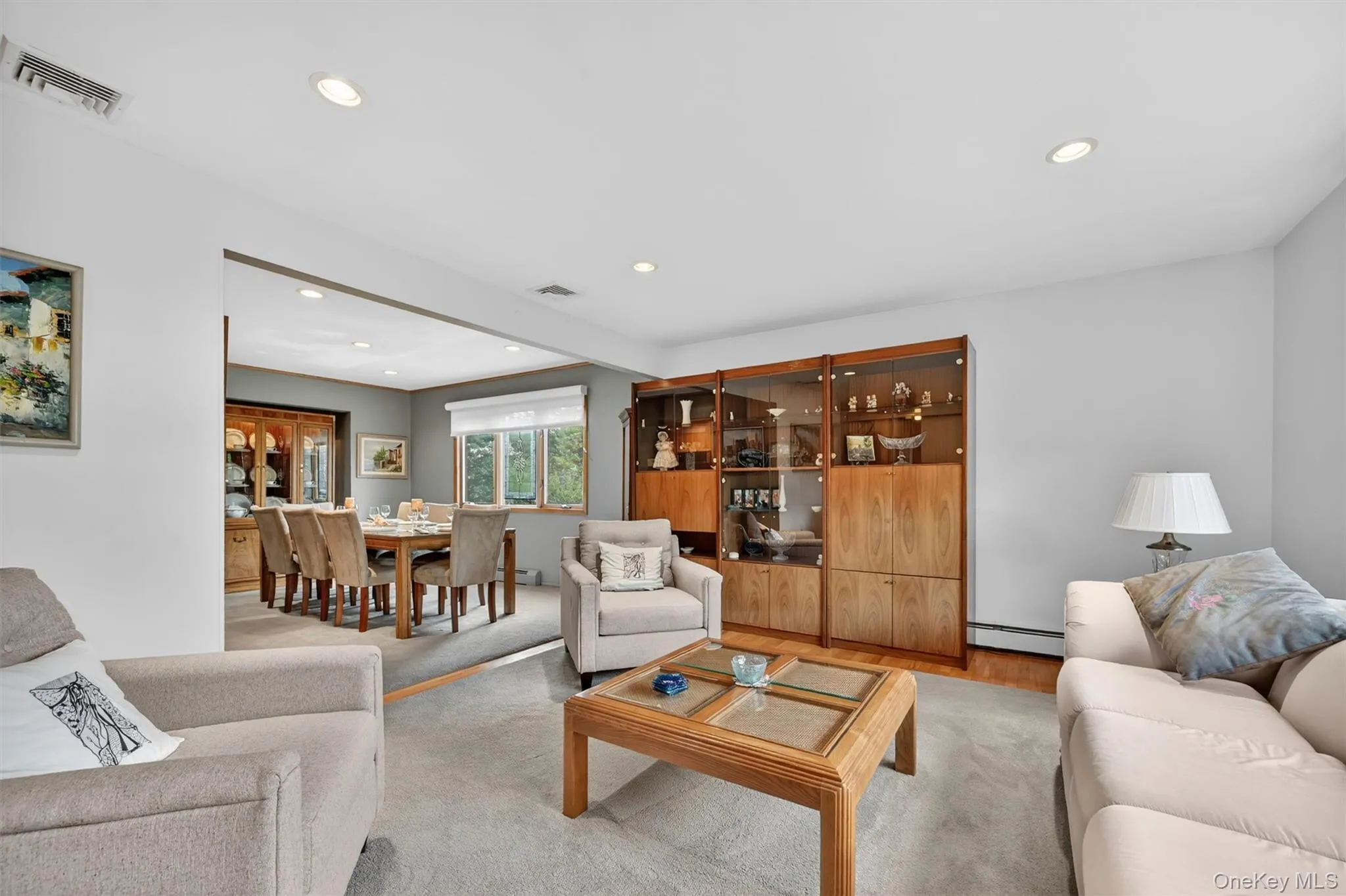 Bright and welcoming living room with a large picture window, abundant natural light, and an open connection to the dining area. Bright and welcoming living room with a large picture window, abundant natural light, and an open connection to the dining area.