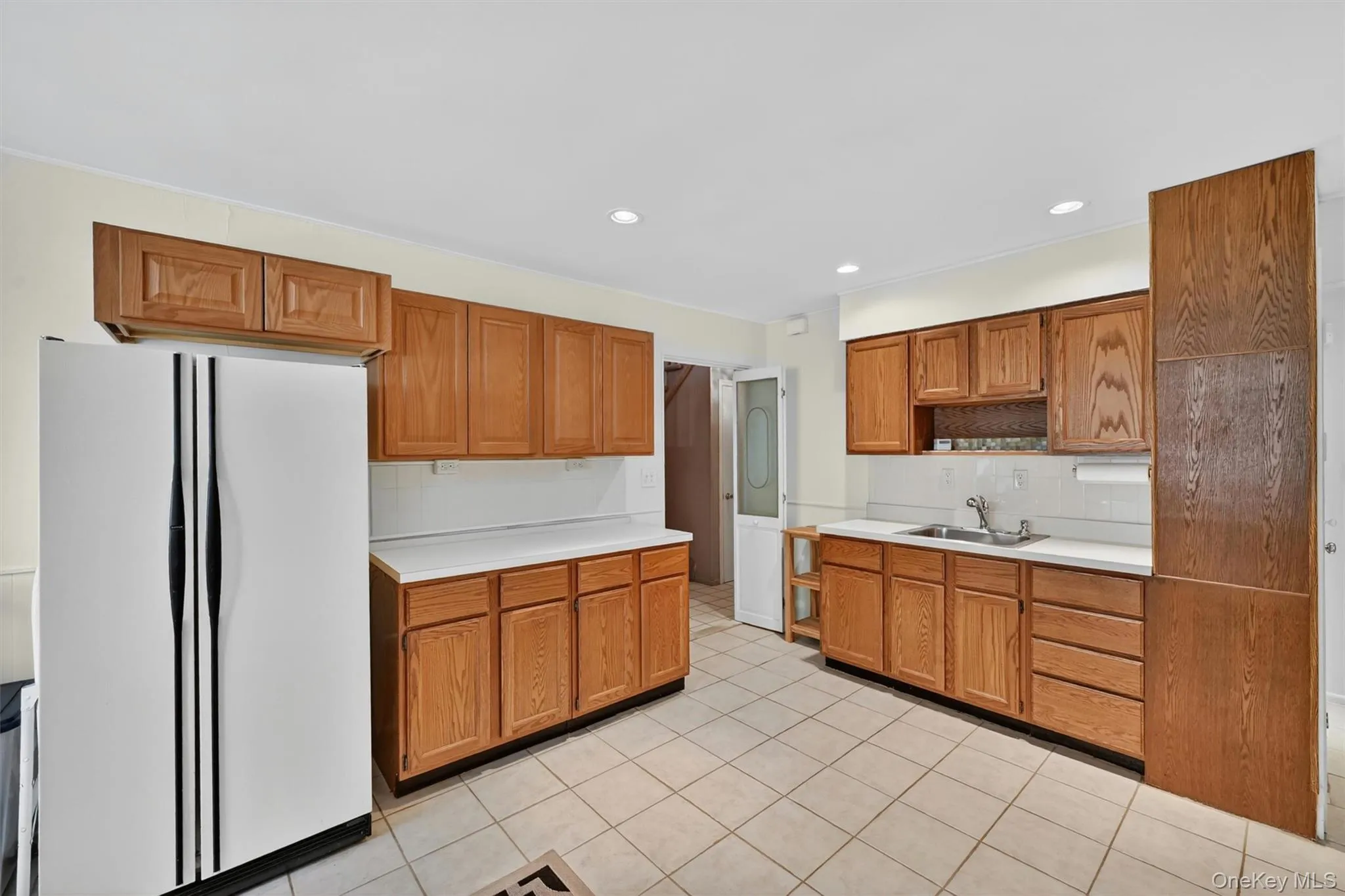 Well-equipped second kitchen featuring plentiful cabinet space, a dining area, and versatility for a variety of household needs. Well-equipped second kitchen featuring plentiful cabinet space, a dining area, and versatility for a variety of household needs.