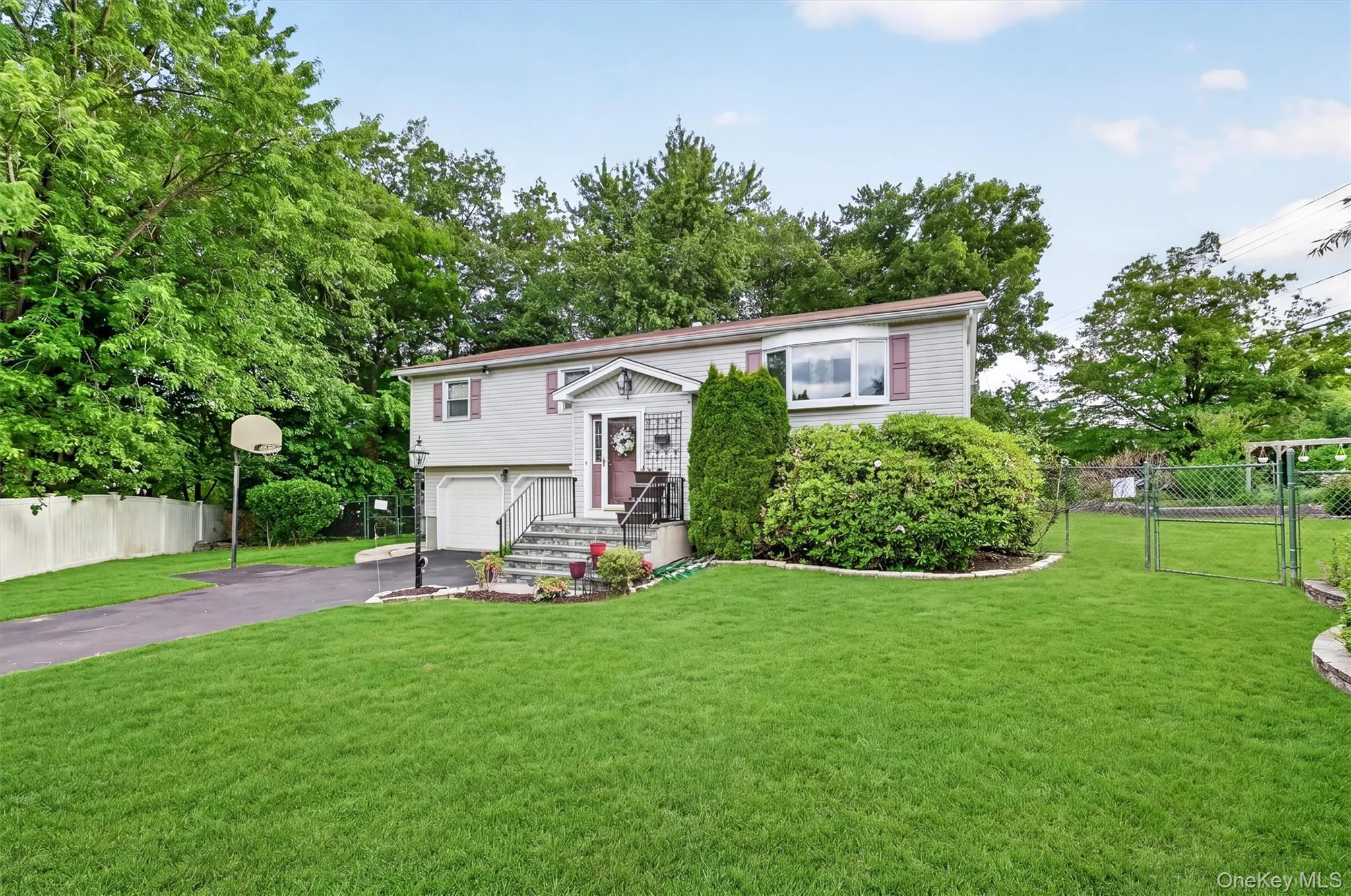 Raised ranch featuring a spacious level yard, mature landscaping, and inviting curb appeal. Raised ranch featuring a spacious level yard, mature landscaping, and inviting curb appeal.