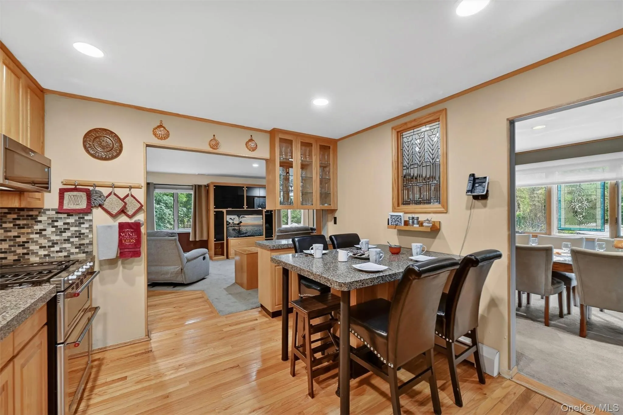 Updated eat-in kitchen featuring granite countertops, stainless steel appliances, abundant cabinetry, and a spacious breakfast area. Updated eat-in kitchen featuring granite countertops, stainless steel appliances, abundant cabinetry, and a spacious breakfast area.
