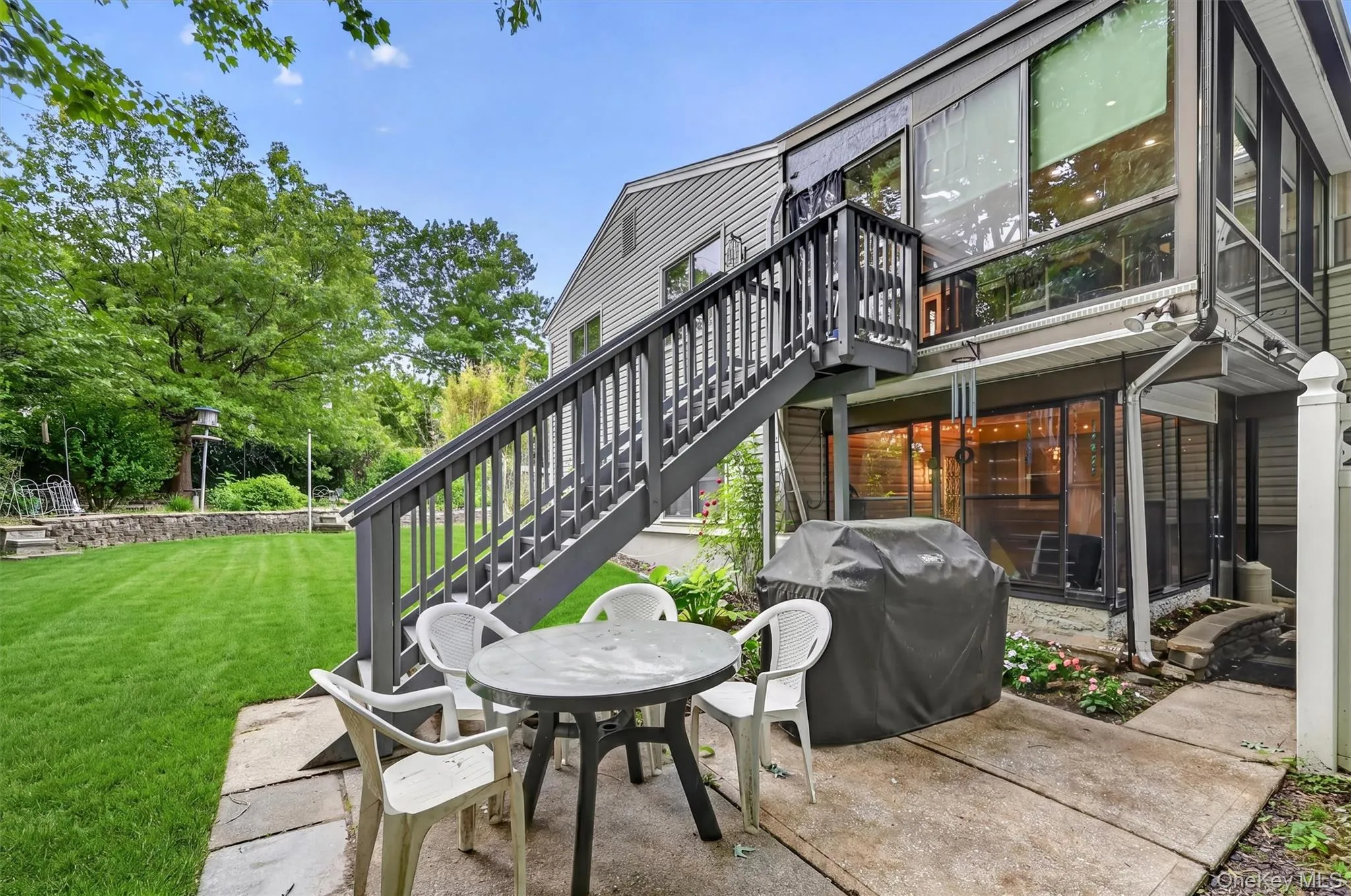 Enjoy outdoor entertaining on the spacious patio overlooking a level backyard, with easy access to the deck above and plenty of room for relaxing, dining, and gathering with guests. Enjoy outdoor entertaining on the spacious patio overlooking a level backyard, with easy access to the deck above and plenty of room for relaxing, dining, and gathering with guests.