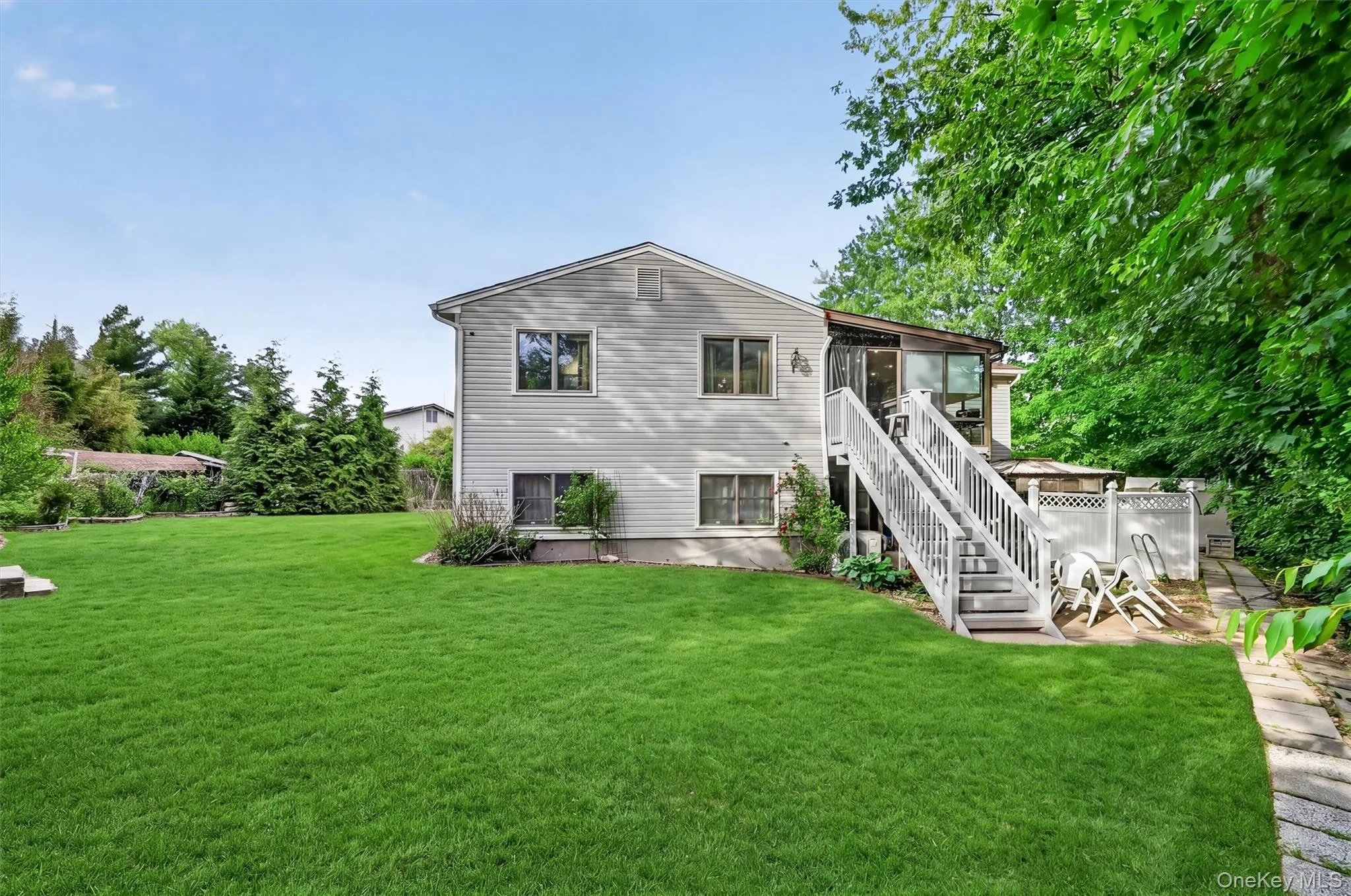Beautifully maintained property featuring a generous lawn, mature trees, and a peaceful backyard retreat. Beautifully maintained property featuring a generous lawn, mature trees, and a peaceful backyard retreat.
