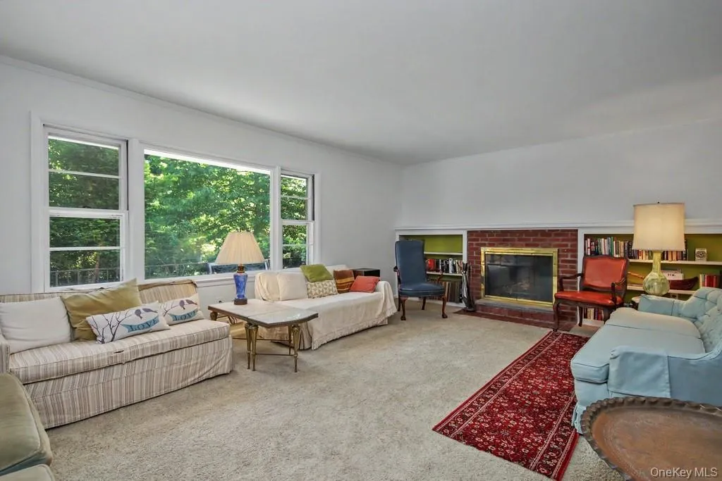 Living Room has a brick fireplace and built in shelves Living Room has a brick fireplace and built in shelves