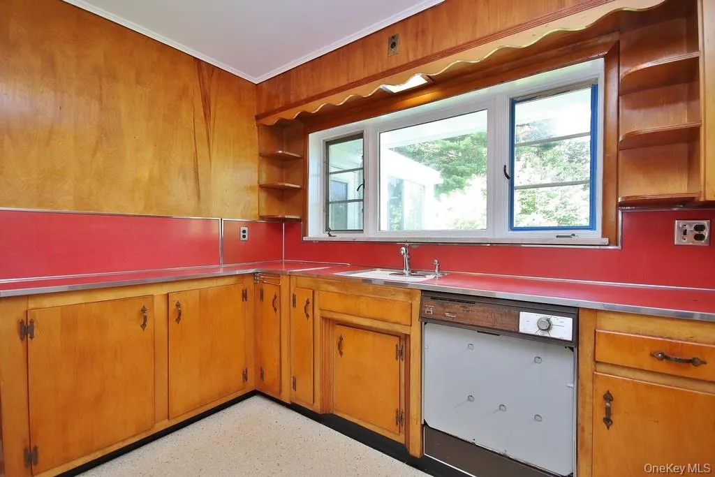 Kitchen has wood cabinetry Kitchen has wood cabinetry
