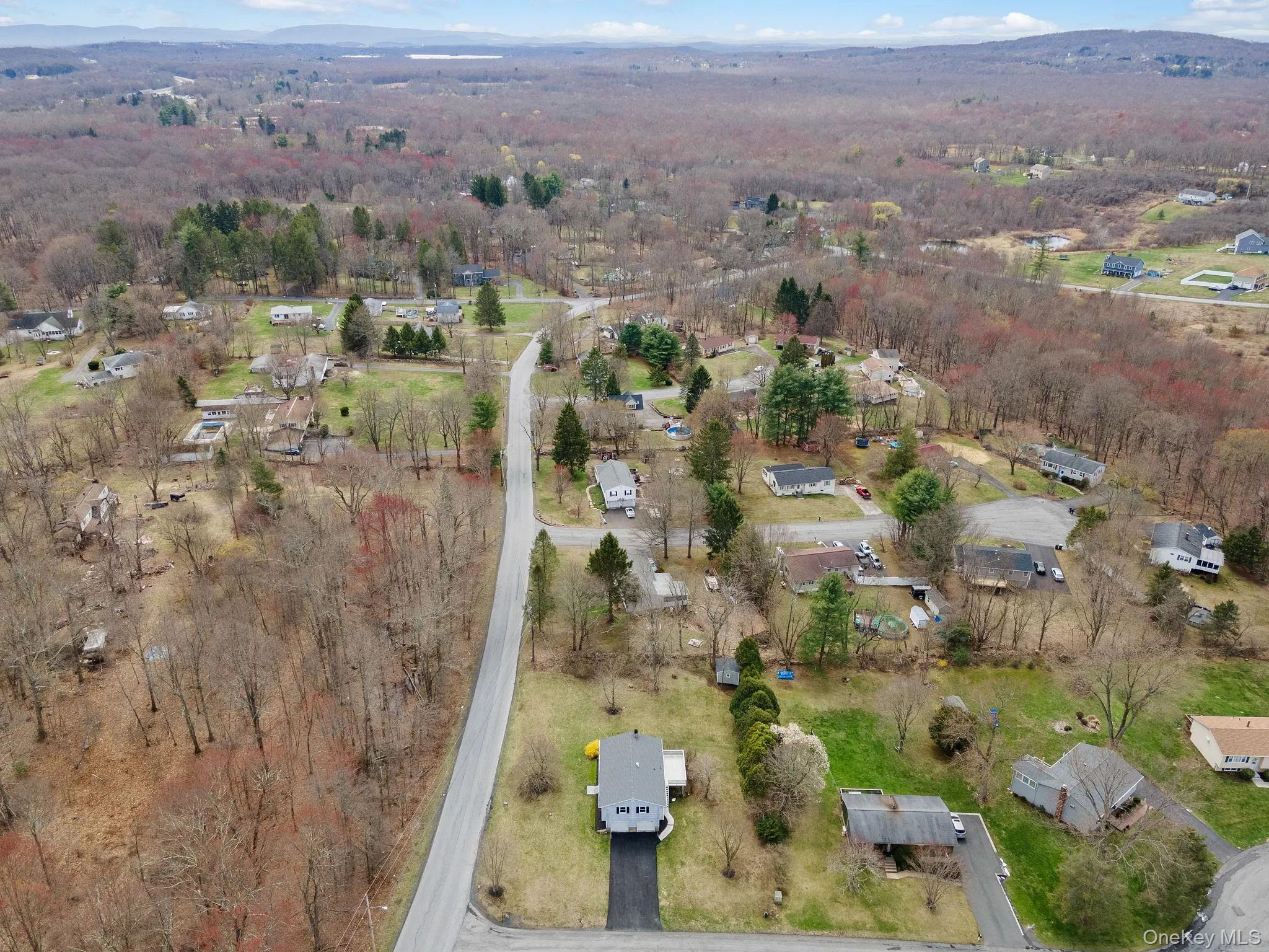 Aerial view featuring a wooded view Aerial view featuring a wooded view