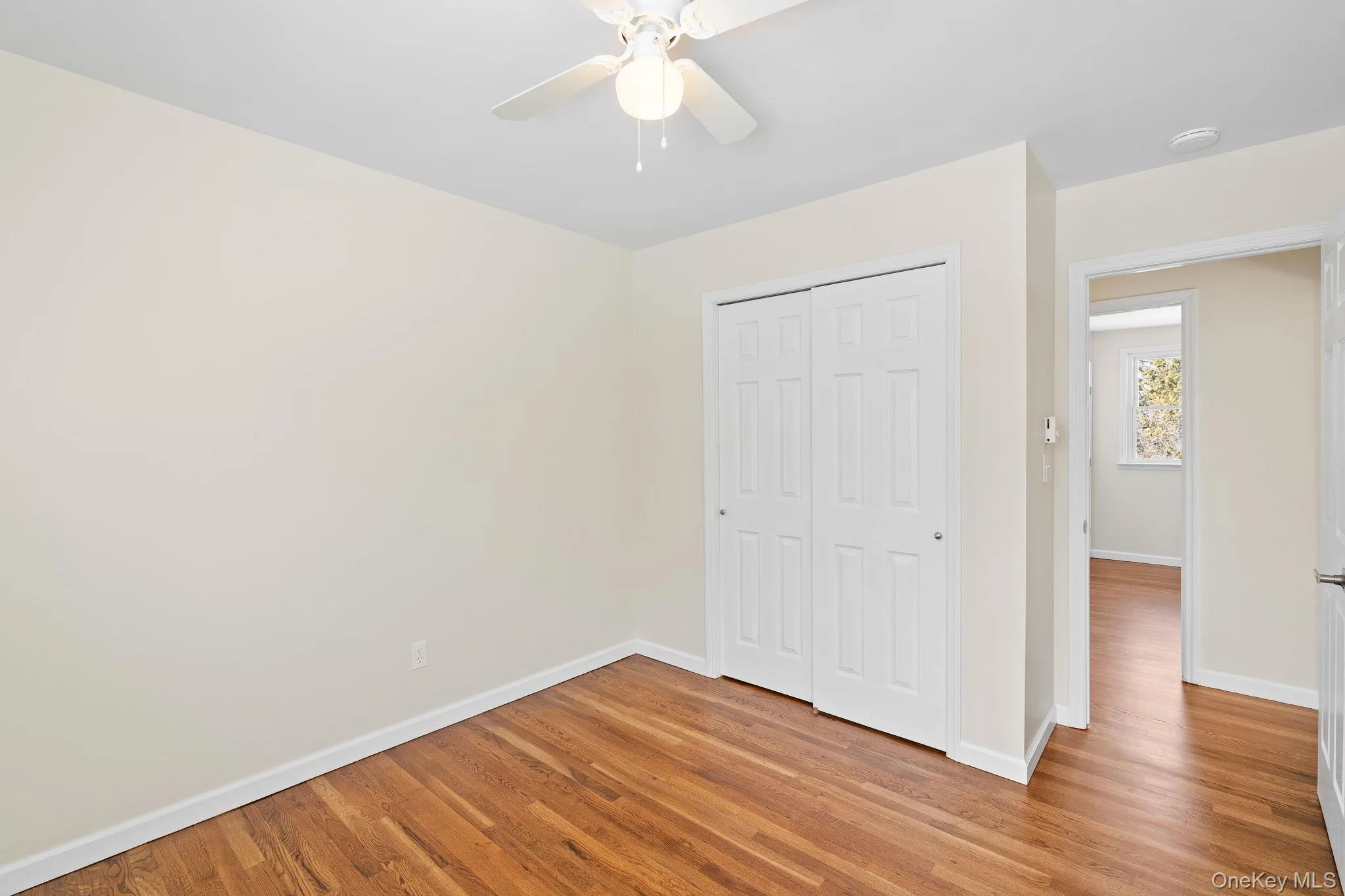 Unfurnished bedroom featuring a closet, ceiling fan, and light hardwood / wood-style flooring Unfurnished bedroom featuring a closet, ceiling fan, and light hardwood / wood-style flooring