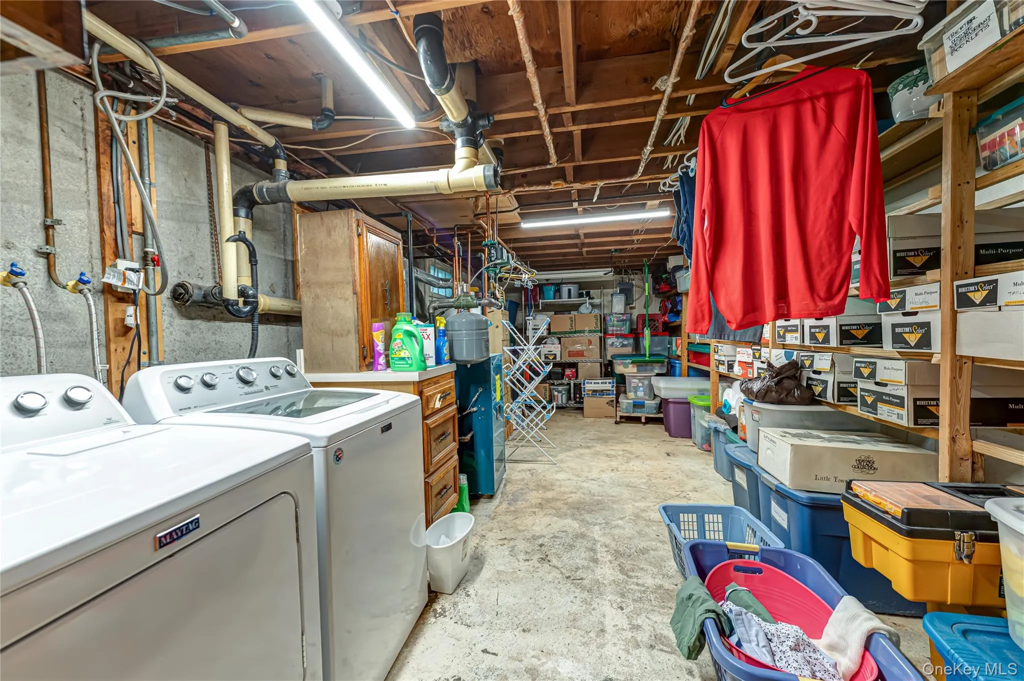 Dedicated laundry area featuring a side-by-side washer and dryer set, concrete flooring and utilities Dedicated laundry area featuring a side-by-side washer and dryer set, concrete flooring and utilities