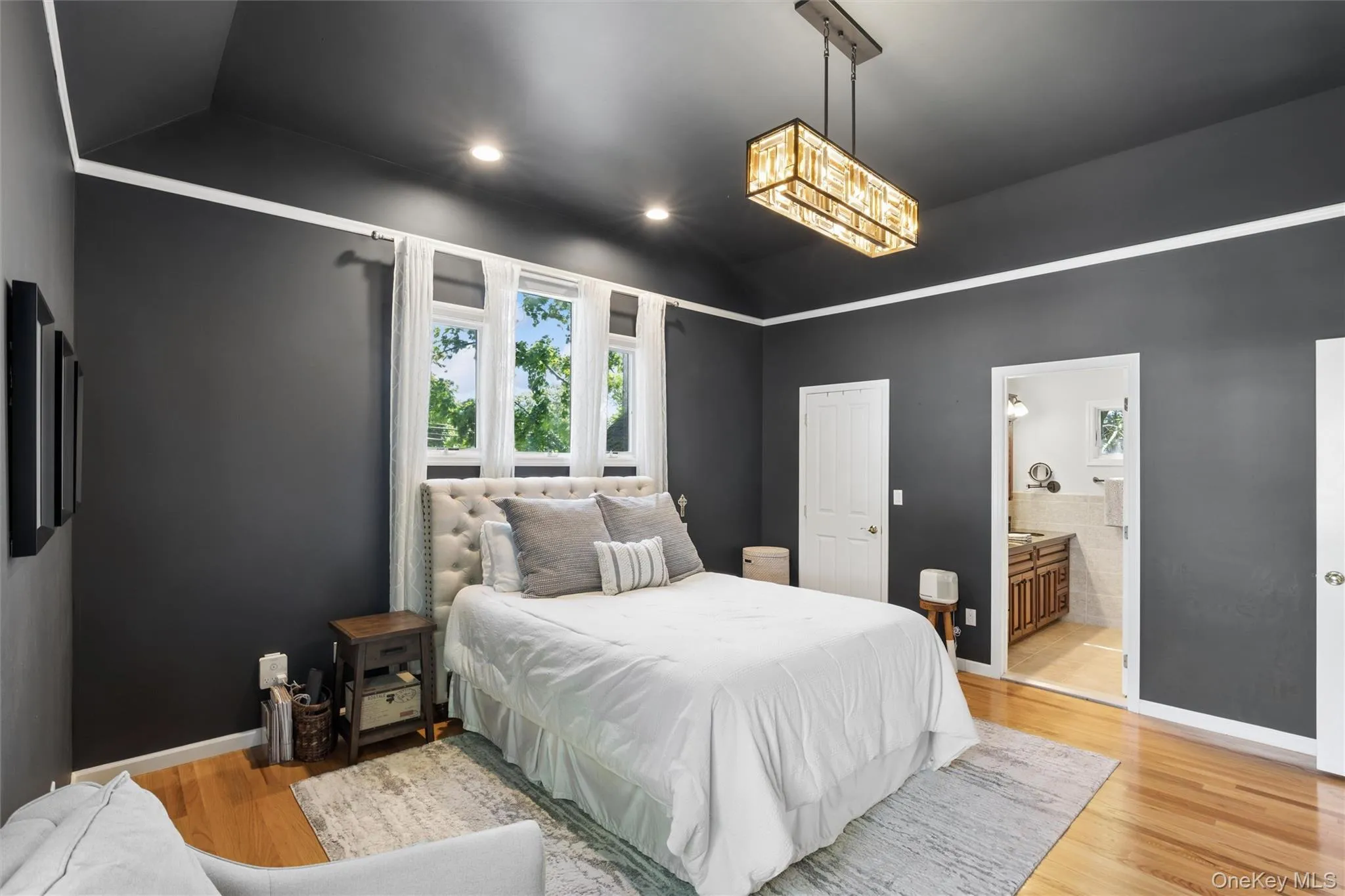 Primary Bedroom with hardwood floors and cathedral custom ceiling Primary Bedroom with hardwood floors and cathedral custom ceiling