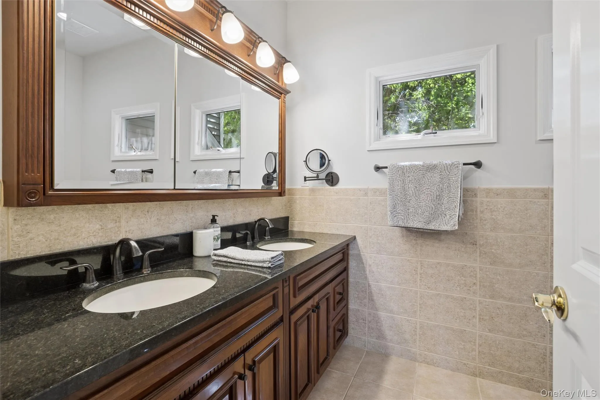 Primary Bathroom with granite double sink and walk in shower/custom tile Primary Bathroom with granite double sink and walk in shower/custom tile
