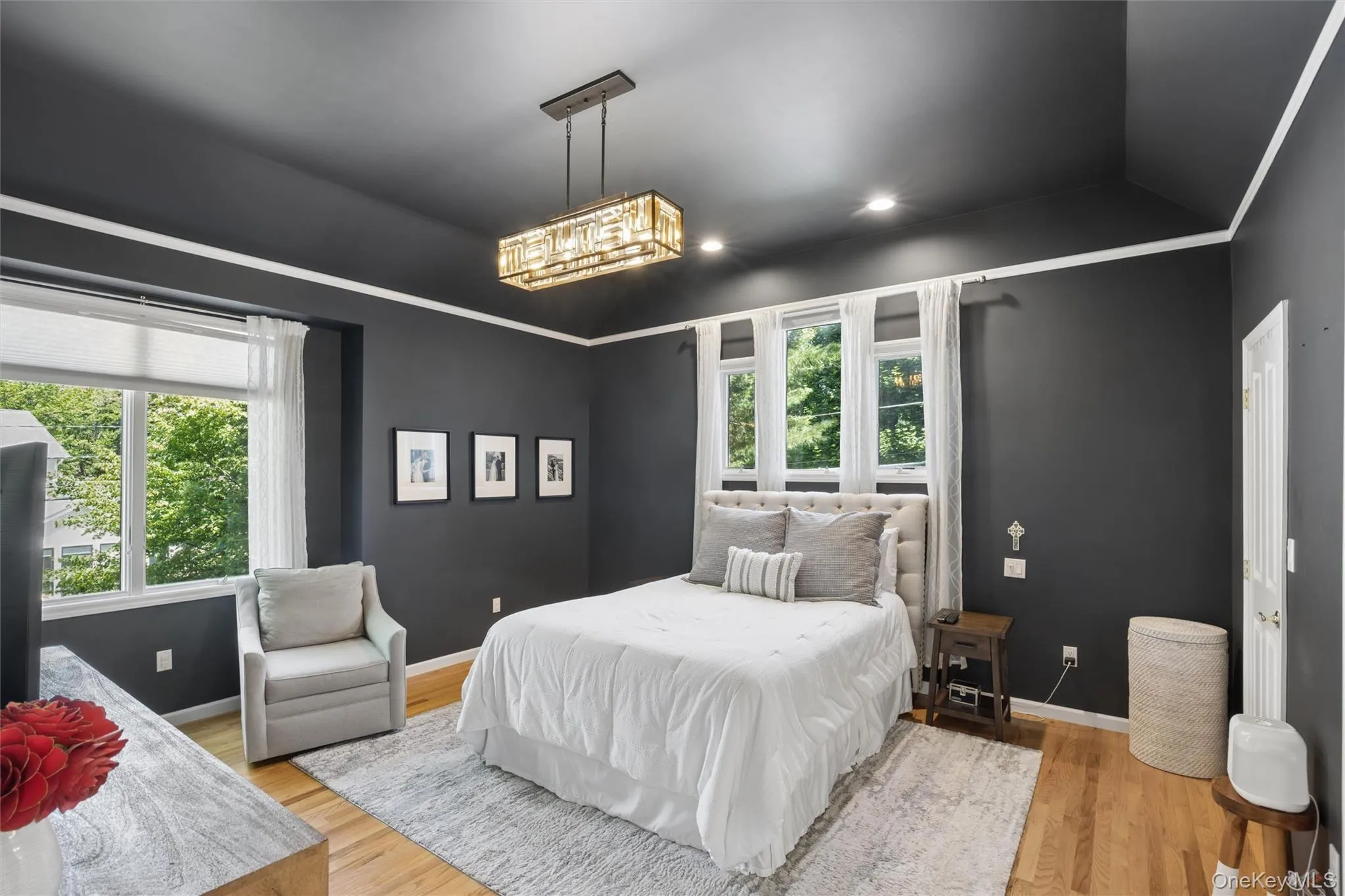 Primary Bedroom with hardwood floors and cathedral custom ceiling Primary Bedroom with hardwood floors and cathedral custom ceiling