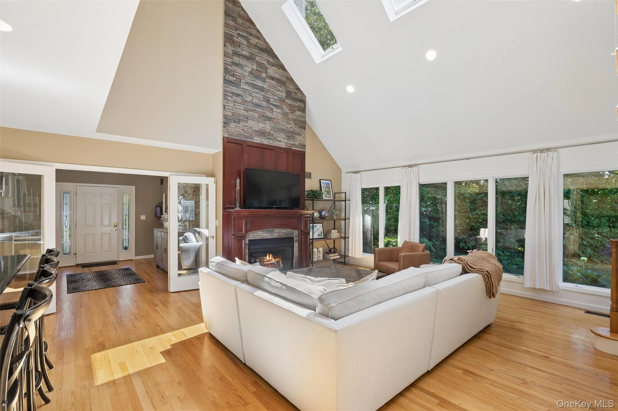 French doors leading to living room, Cathedral ceilings, walls of windows overlooking the manicured flat property French doors leading to living room, Cathedral ceilings, walls of windows overlooking the manicured flat property